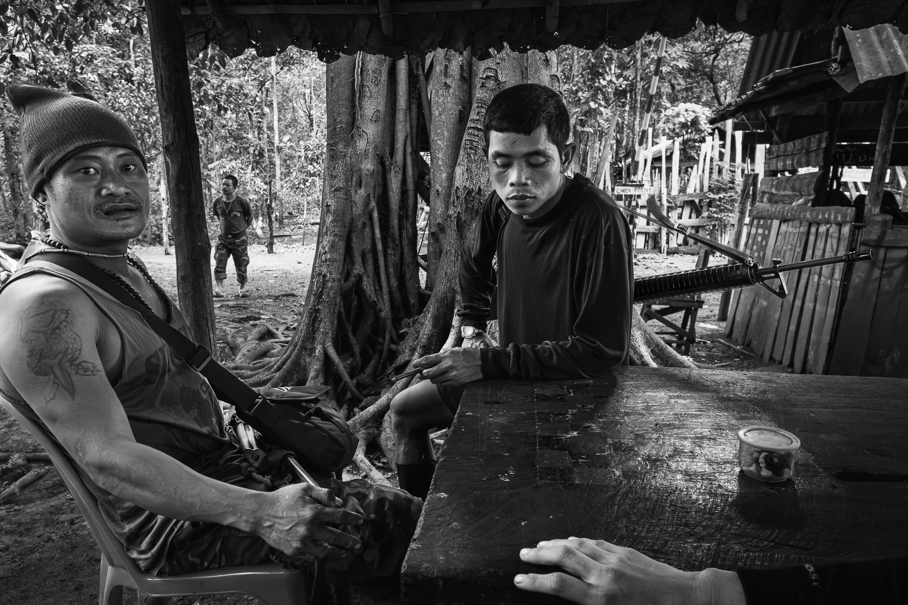 In Myanmar's Karen State, KNLA soldiers pause in June 2025, amidst intense battles for key border areas.