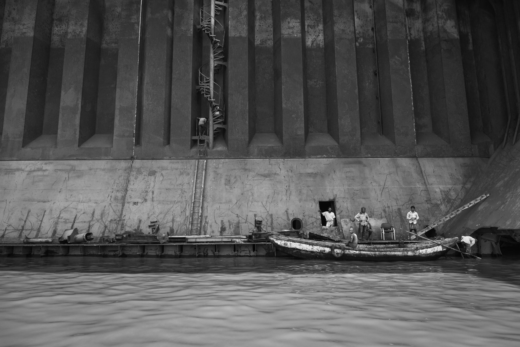 Ship-breaking yard workers reaching the inner side of the ship's hull, Kumira ship-breaking yards, Bangladesh, June 2015
