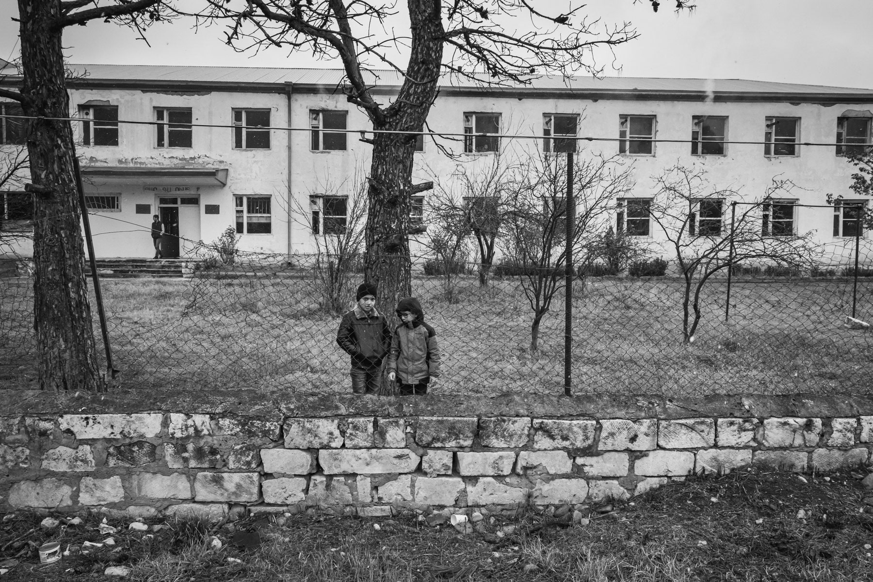 Children in front of the school of Getavan village, the school was built during the Soviet time. The classes take place in dire conditions and the classrooms are heated with wood-fired stoves. Getavan village is since the end of the last war only a couple of kilometeres from territory controlled by Azerbaijan. Nagorno-Karabakh, December 2020