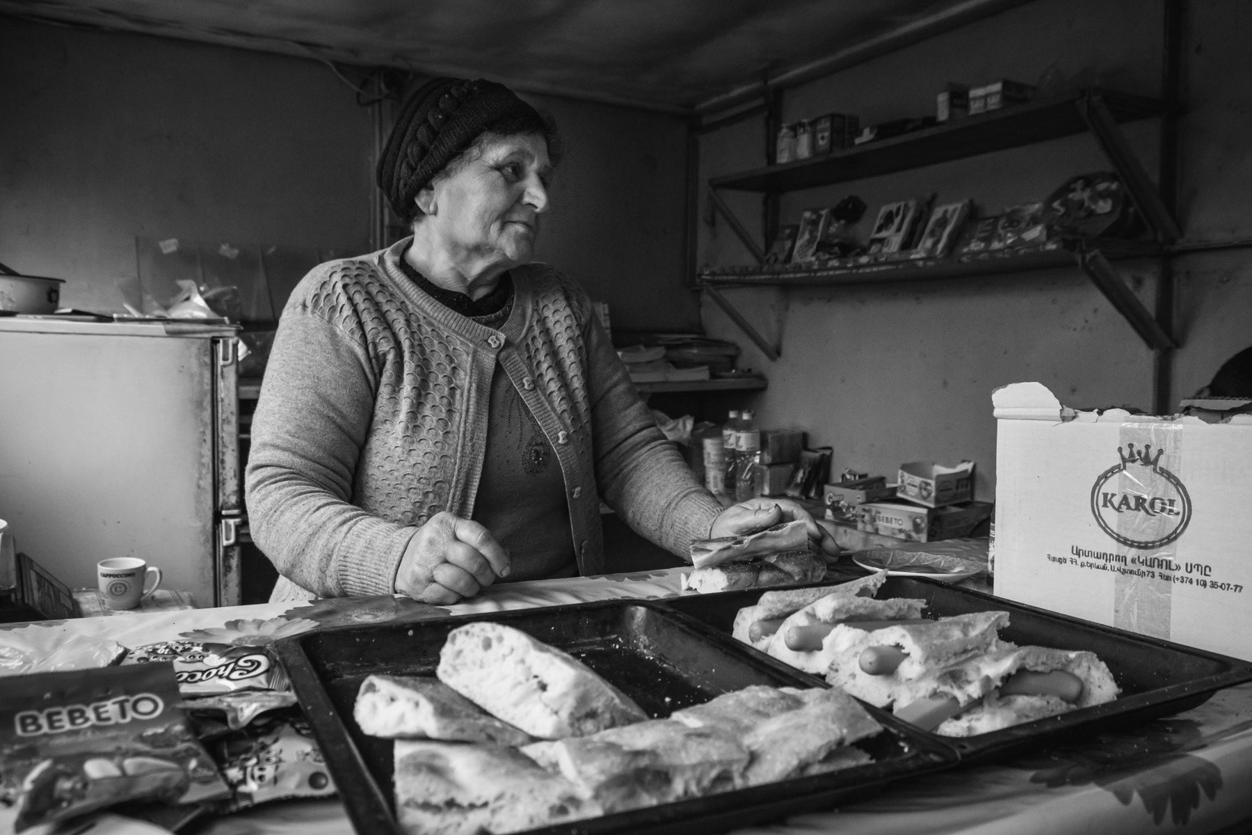 A woman selling sandwiches for students at the end of the classes. Schools have restarted just a couple of weeks after combat operations stopped. Chartar, Nagorno-Karabakh, December 2020