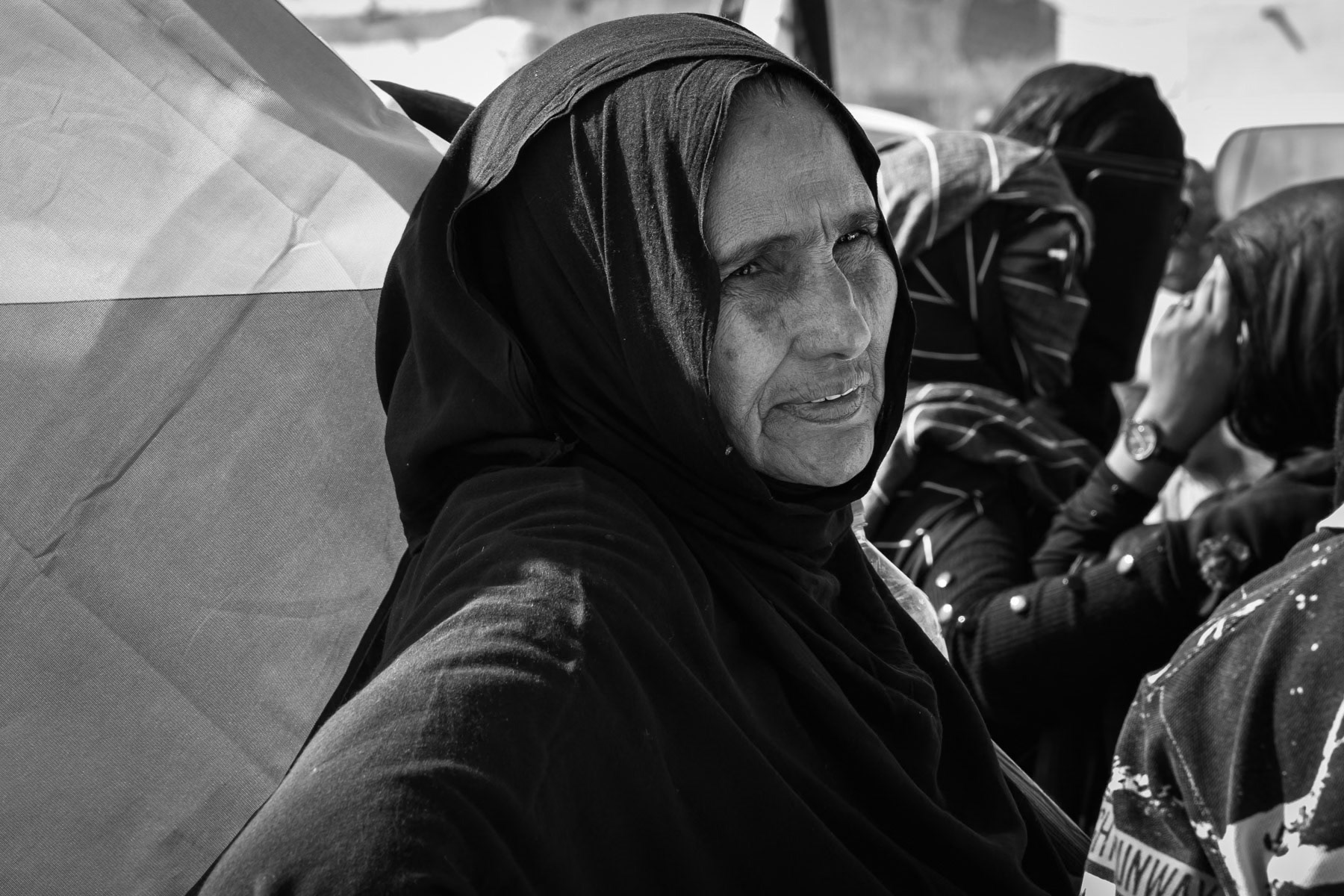 Sahrawi woman with the national flag assisting to festivities at the occasion of the 'National Unity Day of the Sahrawi People'. Boujdor Refugee Camp, Algeria, October 2021