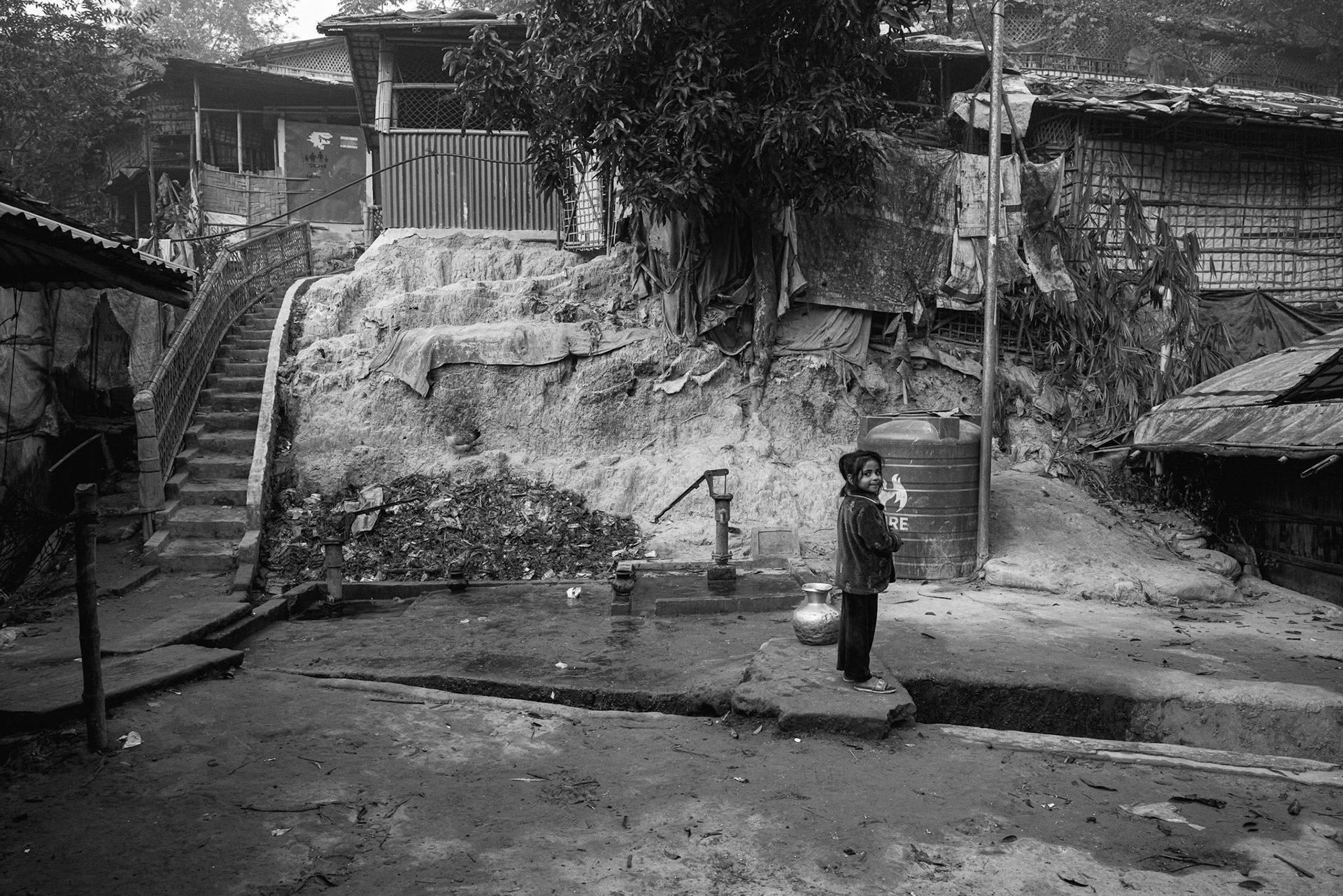 Access to clean water is a daily struggle in the camps, where thousands of people often rely on a single hand pump or distribution tank. Balukhali camp, Bangladesh, January 2026