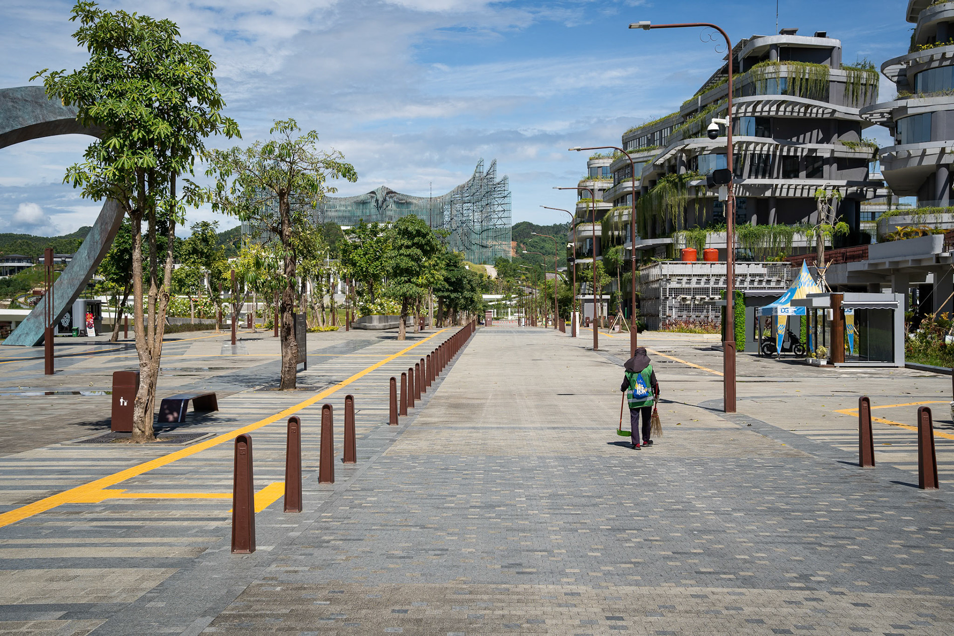 Wide boulevards designed for thousands, currently occupied only by the occasional security detail and maintenance staff. Ibu Kota Nusantara (IKN), Indonesia, January 2026