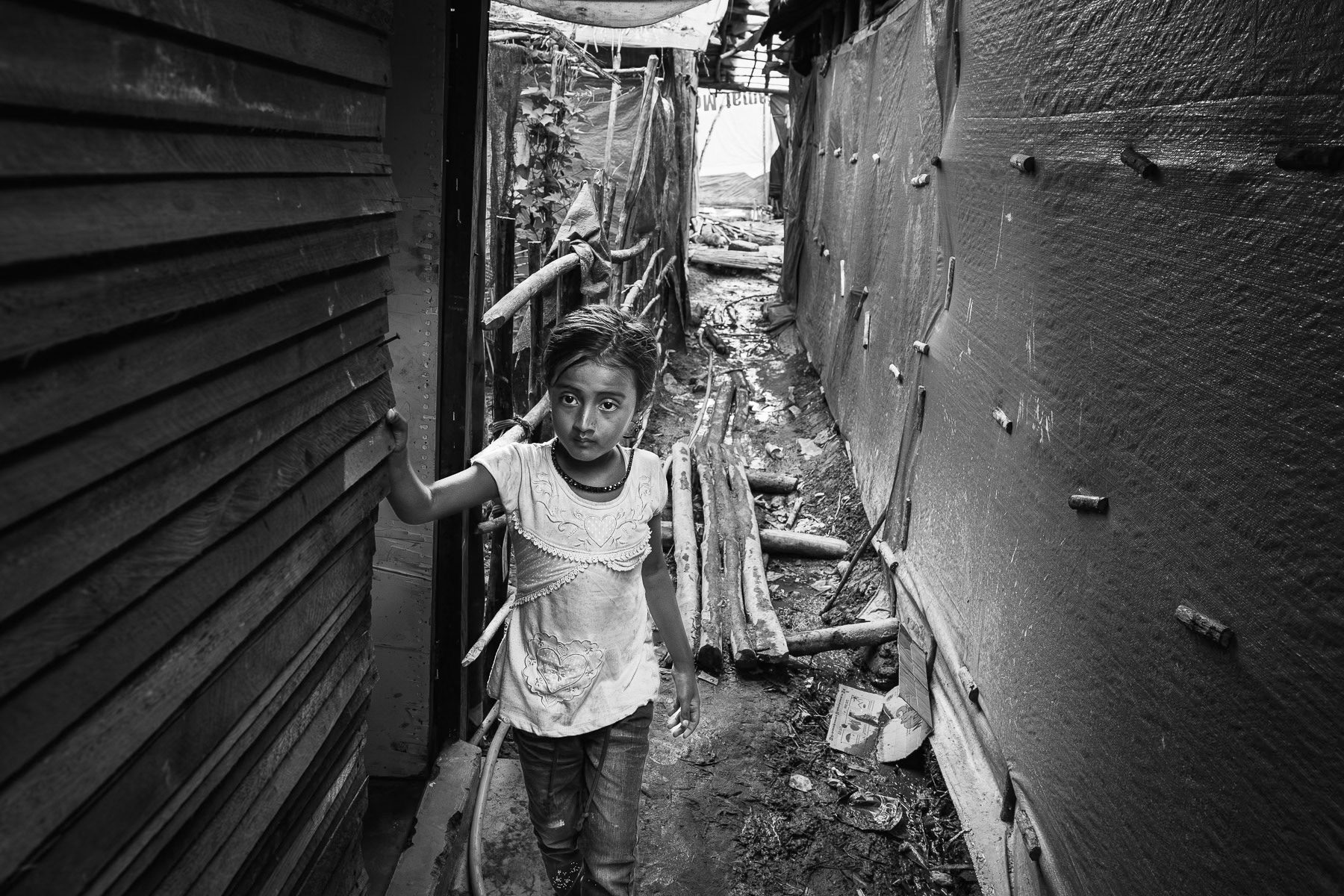 Etched with quiet strength, a Rohingya refugee's journey continues in a makeshift camp, months after a treacherous boat journey. Pekanbaru, Indonesia, May 2025