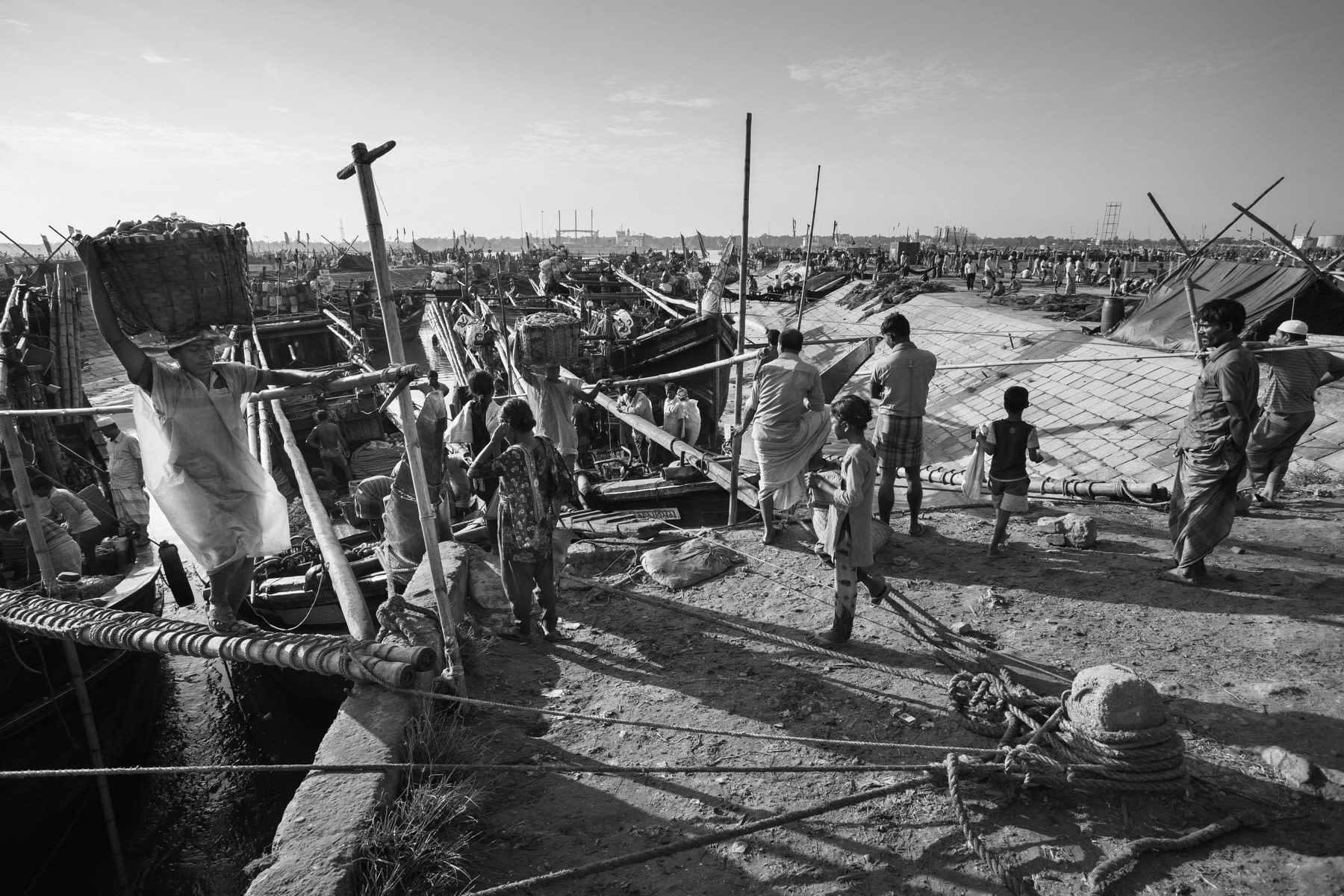 Fishermen usually spend 3 weeks at sea in the Bay of Bengal, exposed to heavy weather, cyclones and sea pirates. When returning at port the fish load is collected by the boat owners and sold at a great profit. The Fishermen stay only few days at port before returning at sea for several weeks. Main fishing port in Chittagong, Bangladesh, October 2014