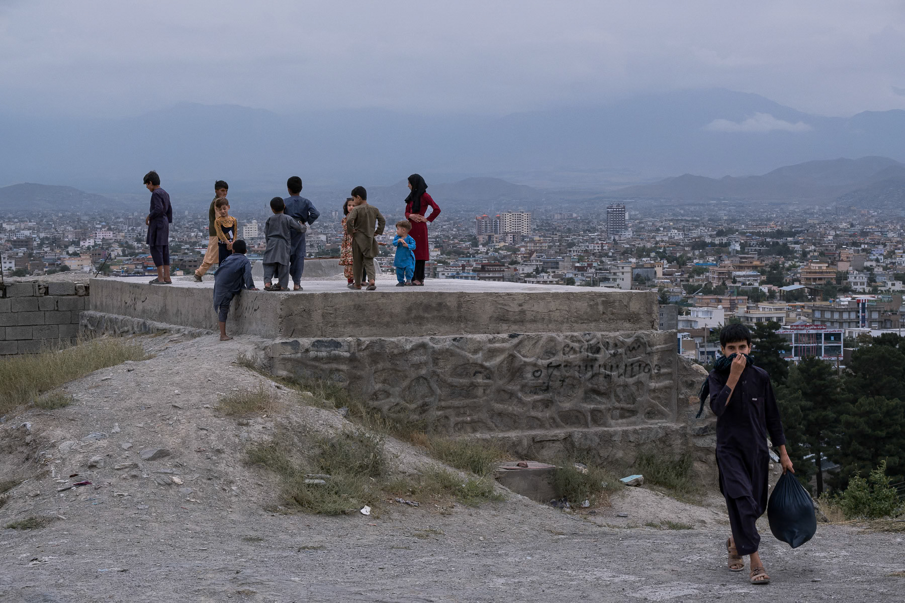 Afghan children playing in a hillside neighbourhood overlooking Kabul, the capital of Afghanistan, August 2024