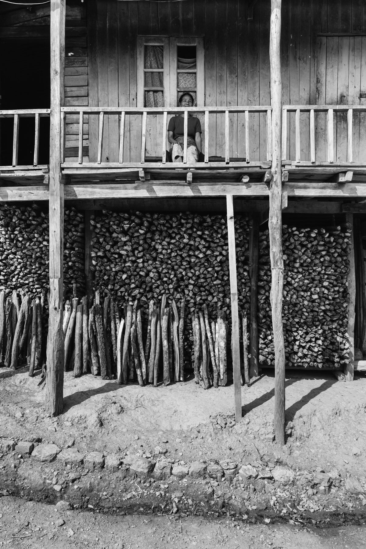 Traditional Chin house with fire wood reserves. Salen village, Chin State, Myanmar, April 2024
