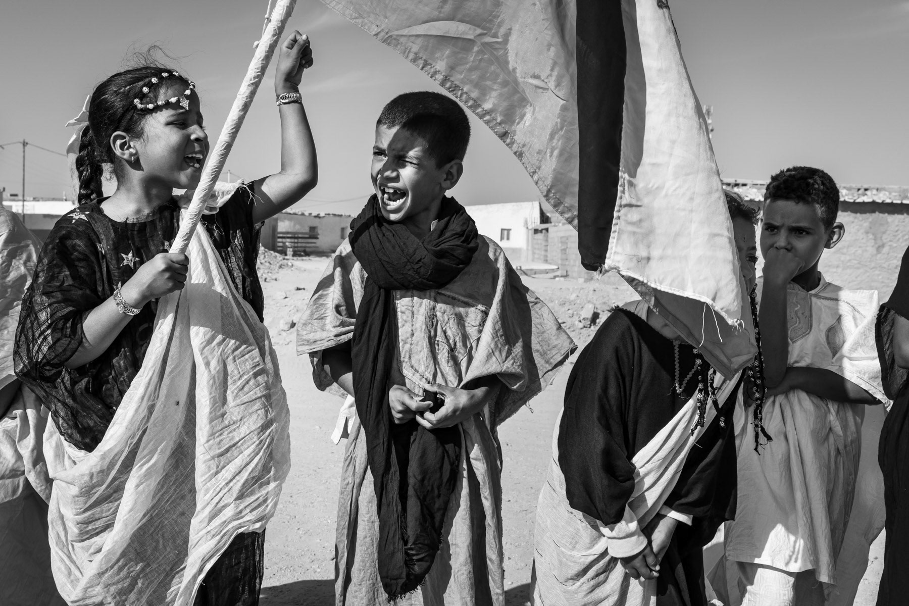 Children rehearsing for the ceremony of the Sahrawi 'Day of Unity', a national day on 12 October. Boujdor Saharawi refugee camp in the Sahara desert, Algeria, October 2021