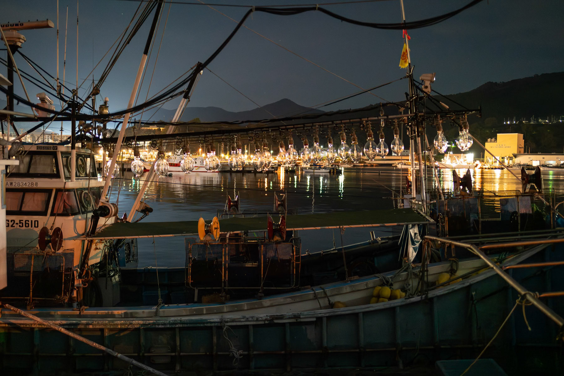 Fishing boat ready to leave at night from Onagawa fishing port some 100 Km north of Fukushima where treated cooling water is being released in the ocean after numerous tests and studies claiming it is not harmful to marine life, environment and people's health. However, confidence is very low and regional boycott have devastated an already affected fishing industry so important for the region. Oganawa, Japan, October 2023