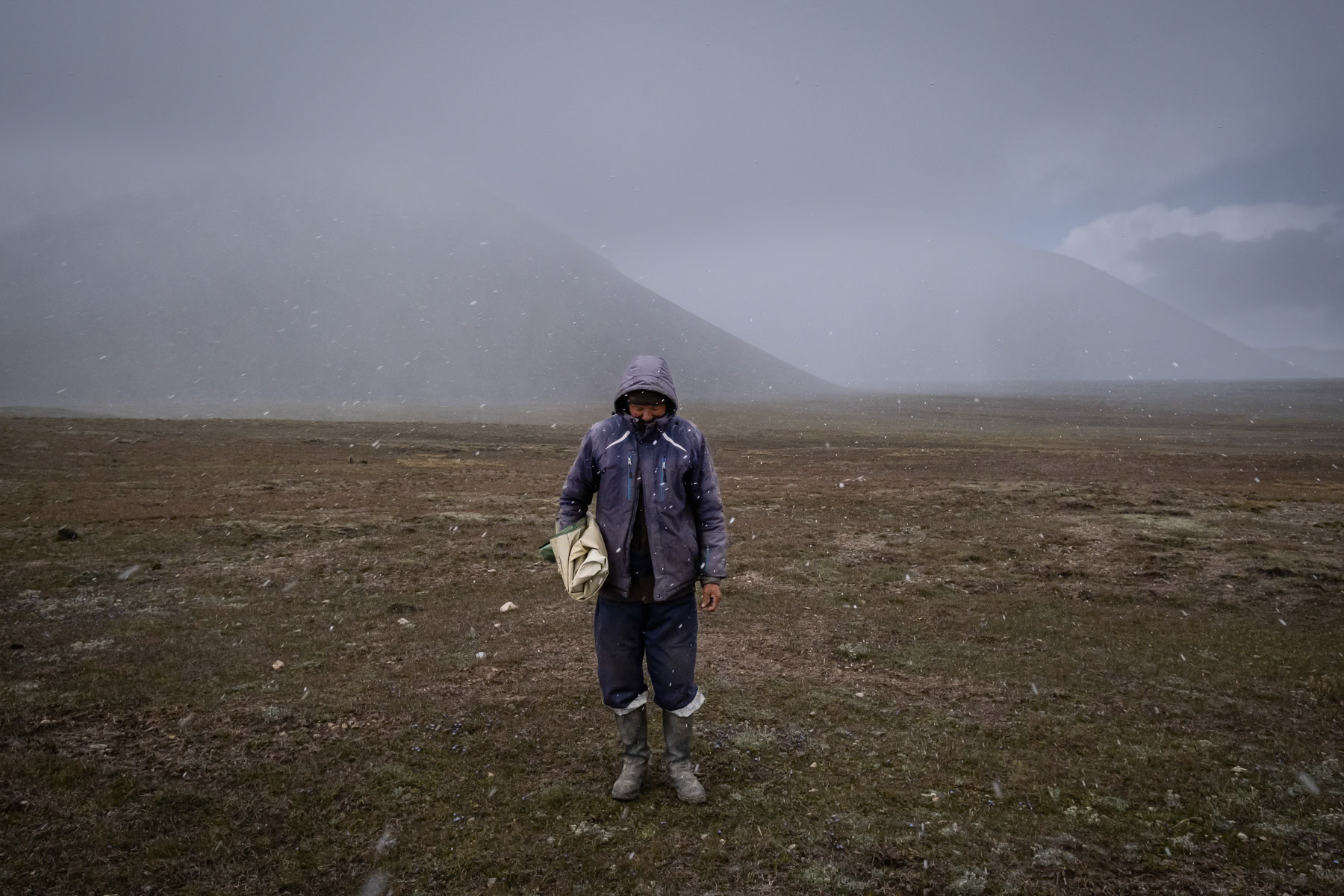 Kyrgyzstan and more generally Central Asia start to experience the effects of climate change first hand causing severe water shortages in the low lands and neighbouring countries and a deficit of energy produced by hydro power plants. Kyrgyzstan consists of a very large propotion of nomadic communities who can witness of the environmental changes they witness down the valleys and at high altitude. Recurrent periods of drought are longer and longer, glaciers are melting at a speed never witnessed before, and green pastures become more difficult to find. In a country of intensive animal breeding, the remaining grasslands are insufficient and over grazing accelerates soil degradation. All new challanges that the communities have to adapt to. The volume of the mighty high altitute rivers is also decreasing due to drought and lack of snow and rain in the mountains, endangering the production of electricity and further reducing the water flow of the rivers downstream. One of those rivers is the Naryn river which has the largest hydro power plants along its route in the region. The Naryn river flows into the Syr Darya which is crucial for irrrigation of the agriculture heartland of Central Asia and who eventually flows into the Aral Sea, or at least what is left of it. At the present pace, Central Asia could easily become a future hotspot of water and energy conflicts. Low intensity conflicts already occur between Kyrgyzstan, Tajikistan and Uzbekistan. Asambek, 60 years, has been a shepherd since his youngest age. Stays nearly 3 months at an altitude of 4,000m with his herd of 750 sheeps and his younger brother to help him. Arabel, Issyk Kul region, Kyrgyzstan, August 2021