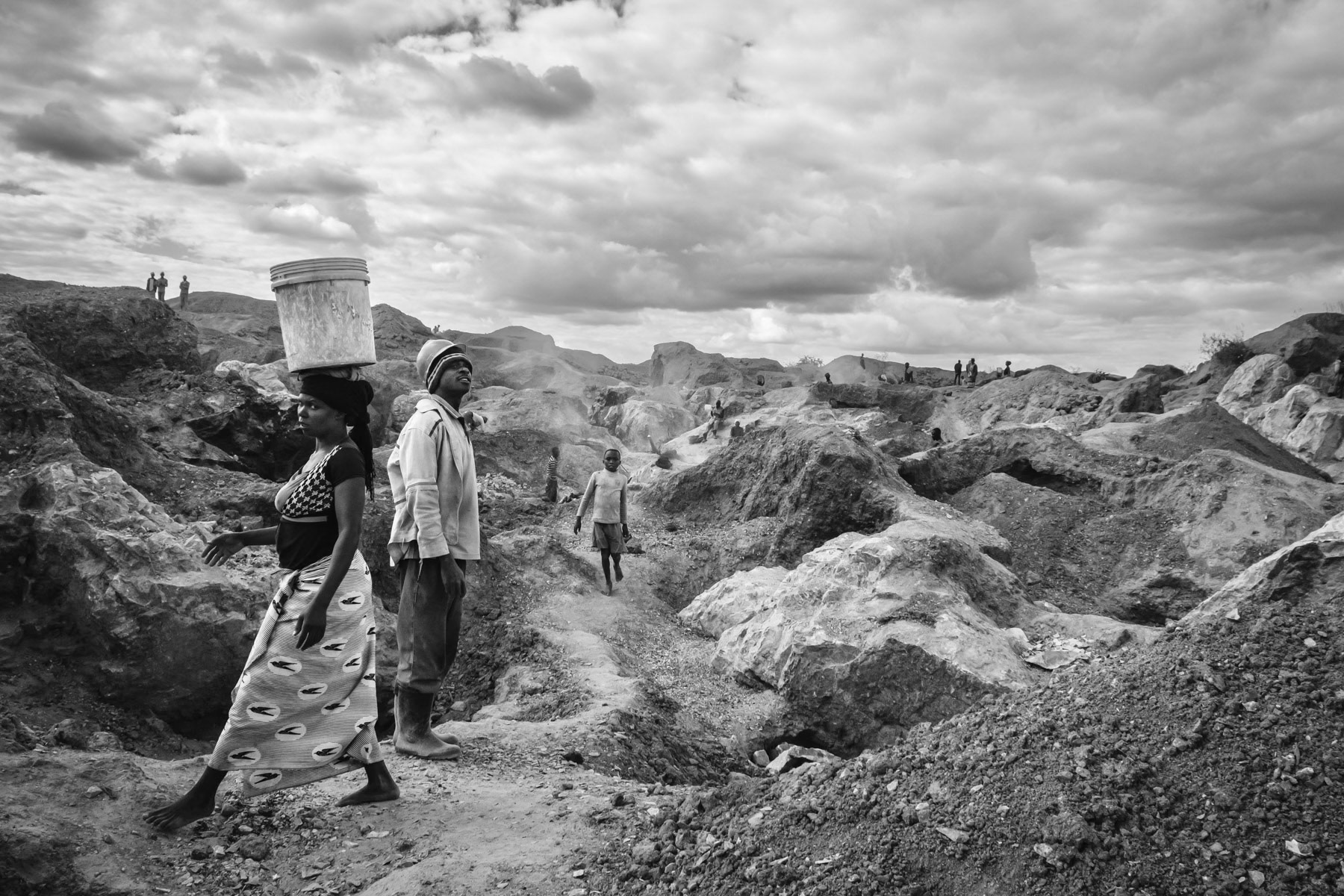 Makululu open pit mine where galena, the mineral form of lead, and dolomite a source of magnesium oxide are being mined by the local community. All labour, including stone crushing is done by hand. Rocks are being burned to make them softer before being extracted. Kabwe, Zambia, May 2021