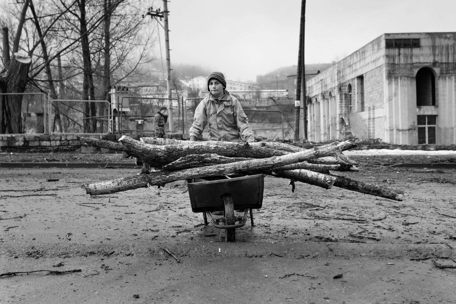 Boy recovering wood for heating in Shushi, March 2014