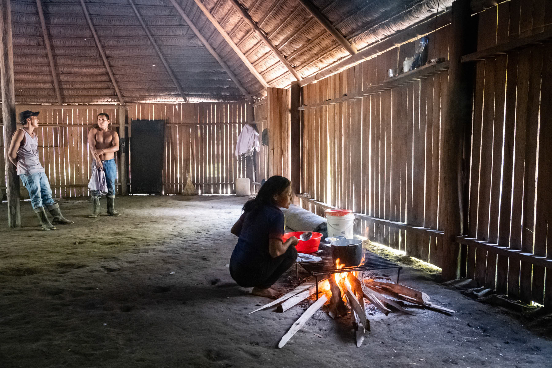 Ms. Kande preparing food on firewood. The indigenous communities are living in remote areas of the amazonian rainforest where no electricity, water or phone signal is available. Everything is done in full harmony with their environment on a subsistance basis. Muruwi tribe, Pocama, Leticia, Colombia, April 2022