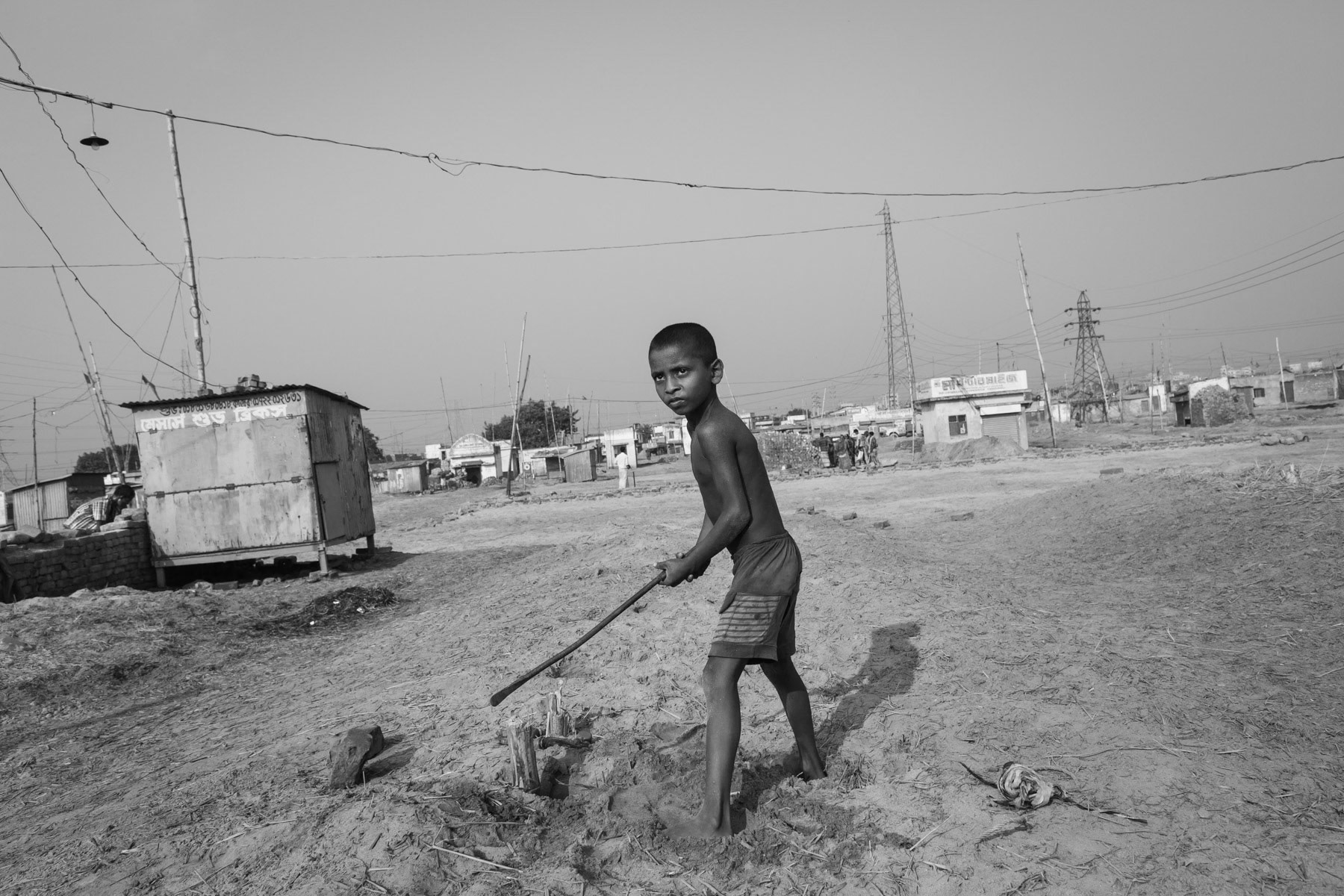 Boy making the space free to store bricks, Gabtoli, Bangladesh, October 2014