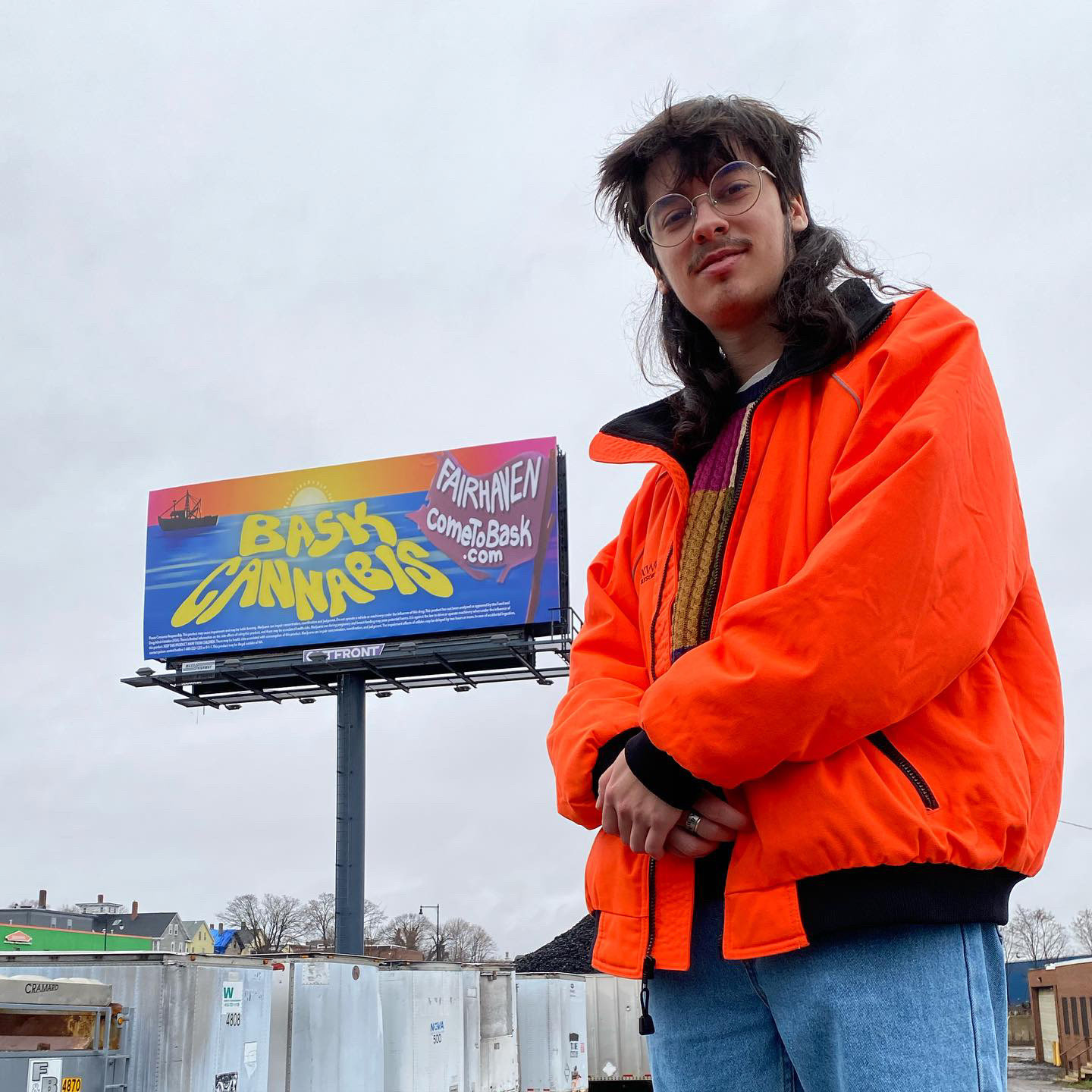 me with one of the billboards I did for BASK Cannabis, in New Bedford MA