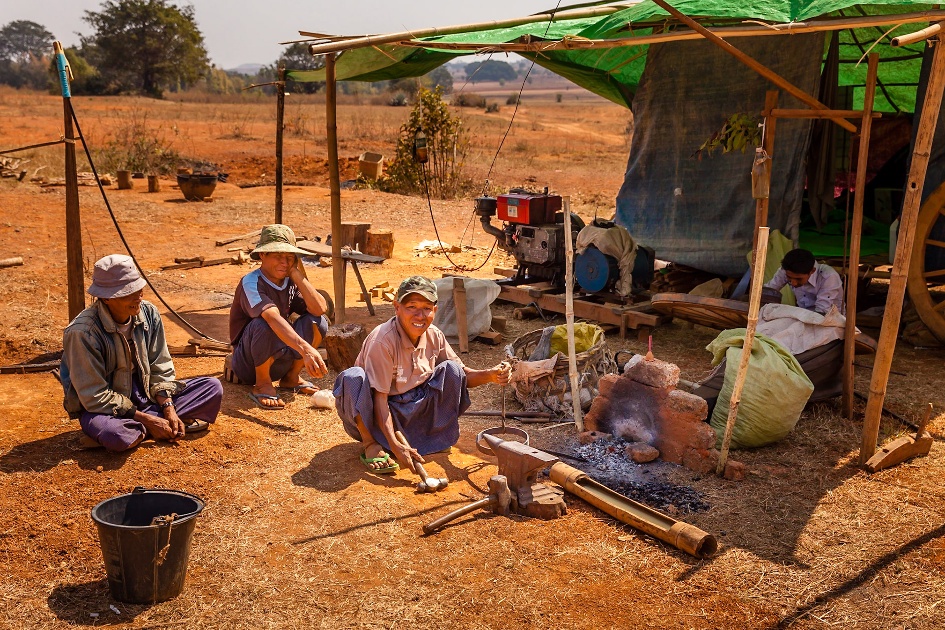 Roadside wagon wheel repair shop, rural Shan State, Myanmar.