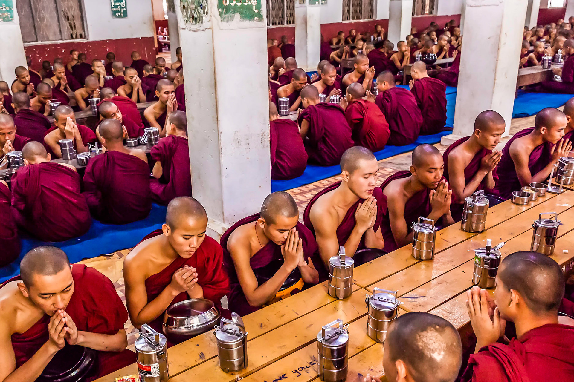 Novice Buddhist monks pray prior to midday meal Yangon