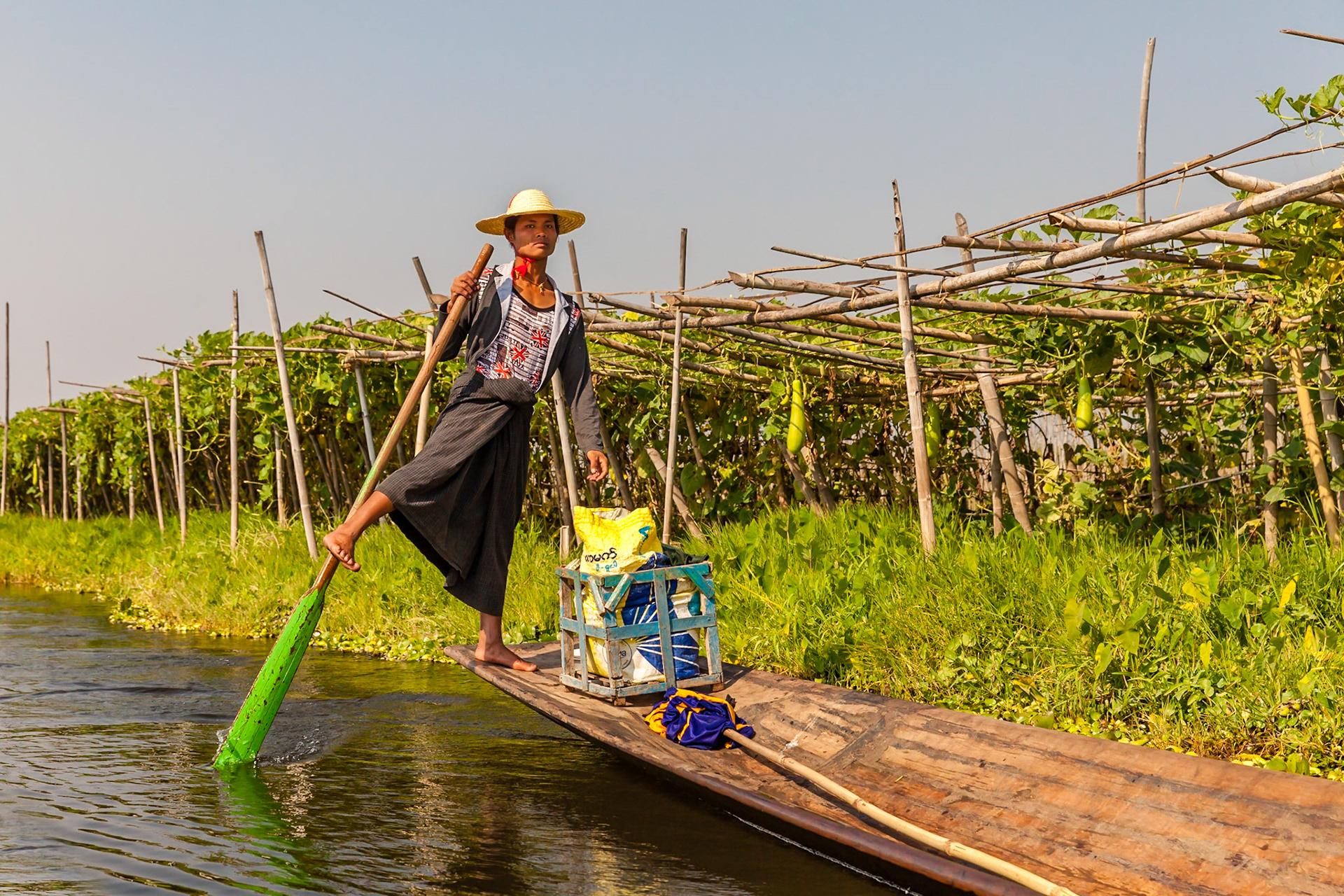 Leg rowing along floating vegetable garden