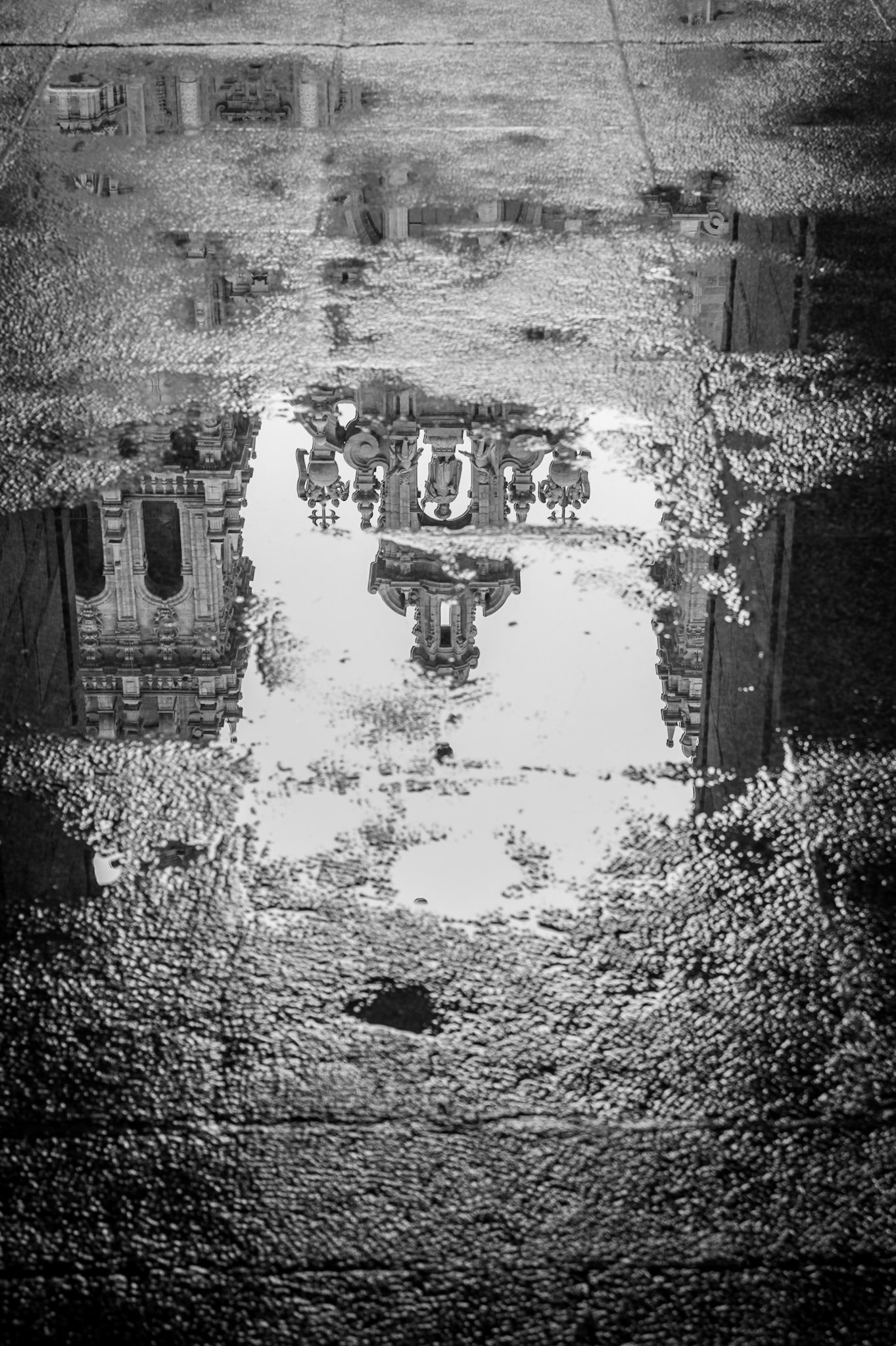 Reflection of the Cathedral of Santiago de Compostela in a rainny autumn morning. Black and white.