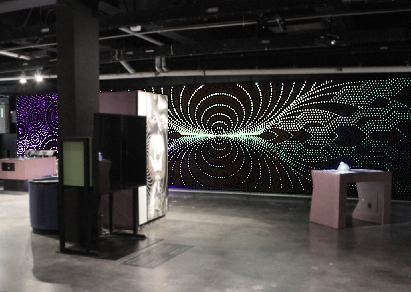 Custom light wall installation celebrating atomic particles, electricity, and magnetism