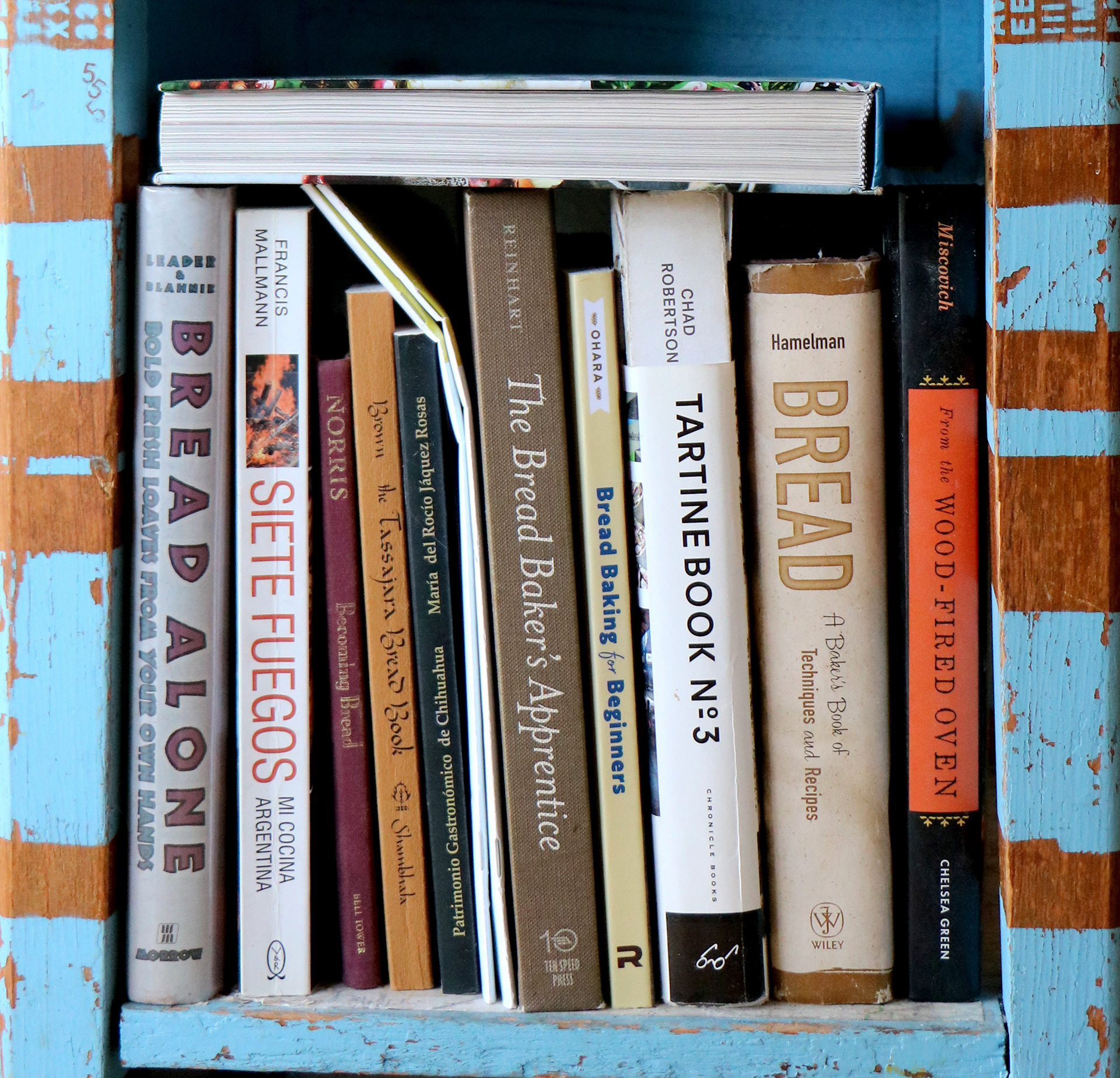 A collection of bread baking books owned by Long Beach baker, Arturo Ensciso.