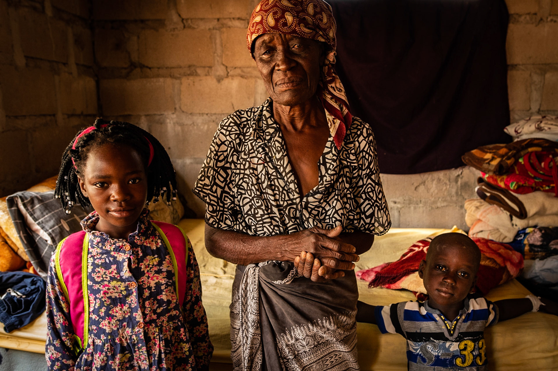 Wesselina Sitoe had two daughters. They both died of AIDS. She is now taking care of her grandchildren. Here she is photographed with two of her six grandchildren in her house in Lionde, Gaza province, Mozambique, this past February. Part of my project Framing and Reframing Memories 40 Years After.
