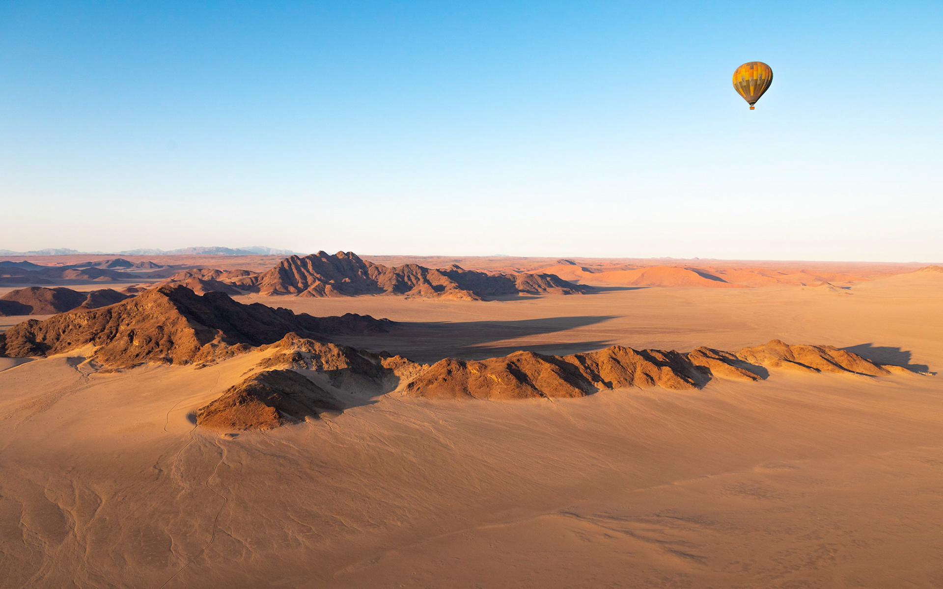 hot air balloon ride; Naukluft mountains with the Sossusvlei red dunes in the distance