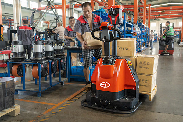 EP XP15 automated pallet truck (co-bot), robot beside a production line