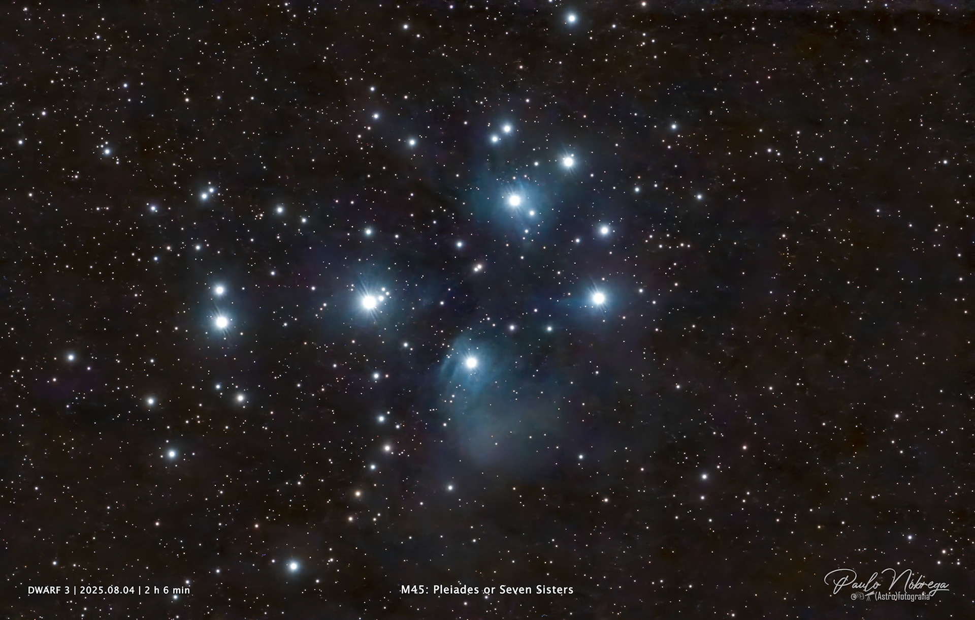 The Pleiades (Messier 45) — Open Star Cluster &amp; Reflection NebulaLocated approximately 444 light-years away in the constellation Taurus, the Pleiades (also known as the Seven Sisters) is an open star cluster dominated by hot, luminous blue stars. This deep-sky astrophotography image highlights the faint interstellar dust clouds passing through the cluster, illuminated as a striking blue reflection nebula by the intense light of its youngest stars.