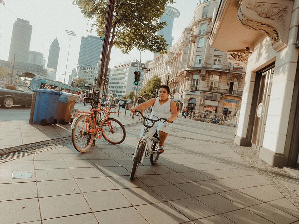 Boy on a bicycle opposite Frankfurt Central Station, 2018