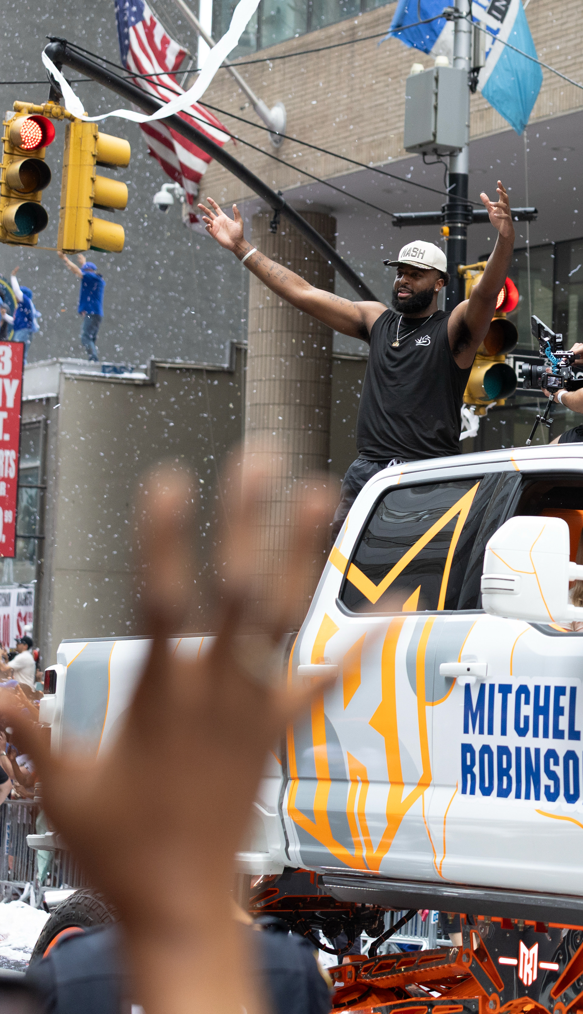 New York Knicks center Mitchell Robinson (23) rides on his truck through the Knick’s ticker tape parade on Thursday, June 18, 2026 in New York, N.Y.