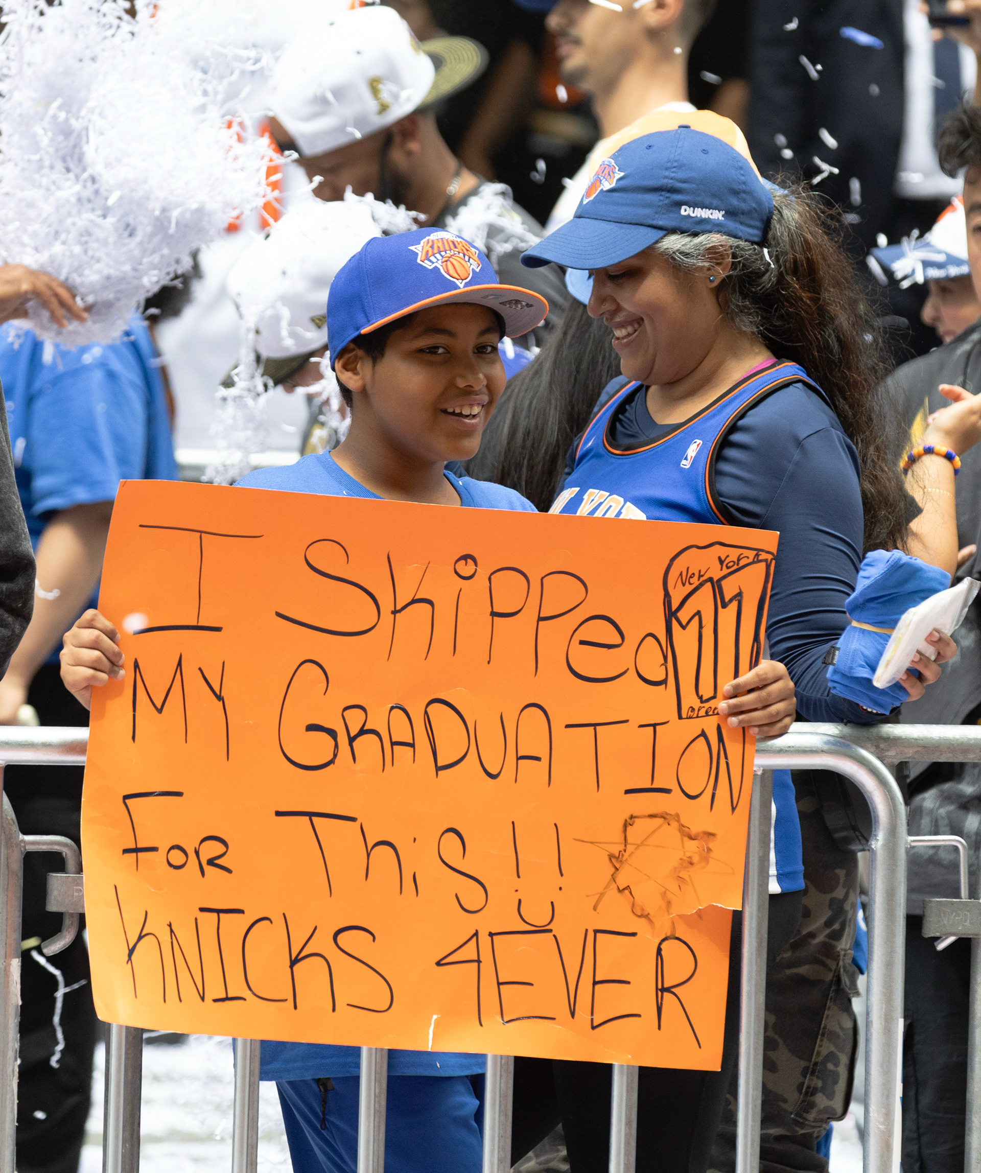 A young Knicks fan poses with a banner during the Knick’s ticker tape parade on Thursday, June 18, 2026 in New York, N.Y.