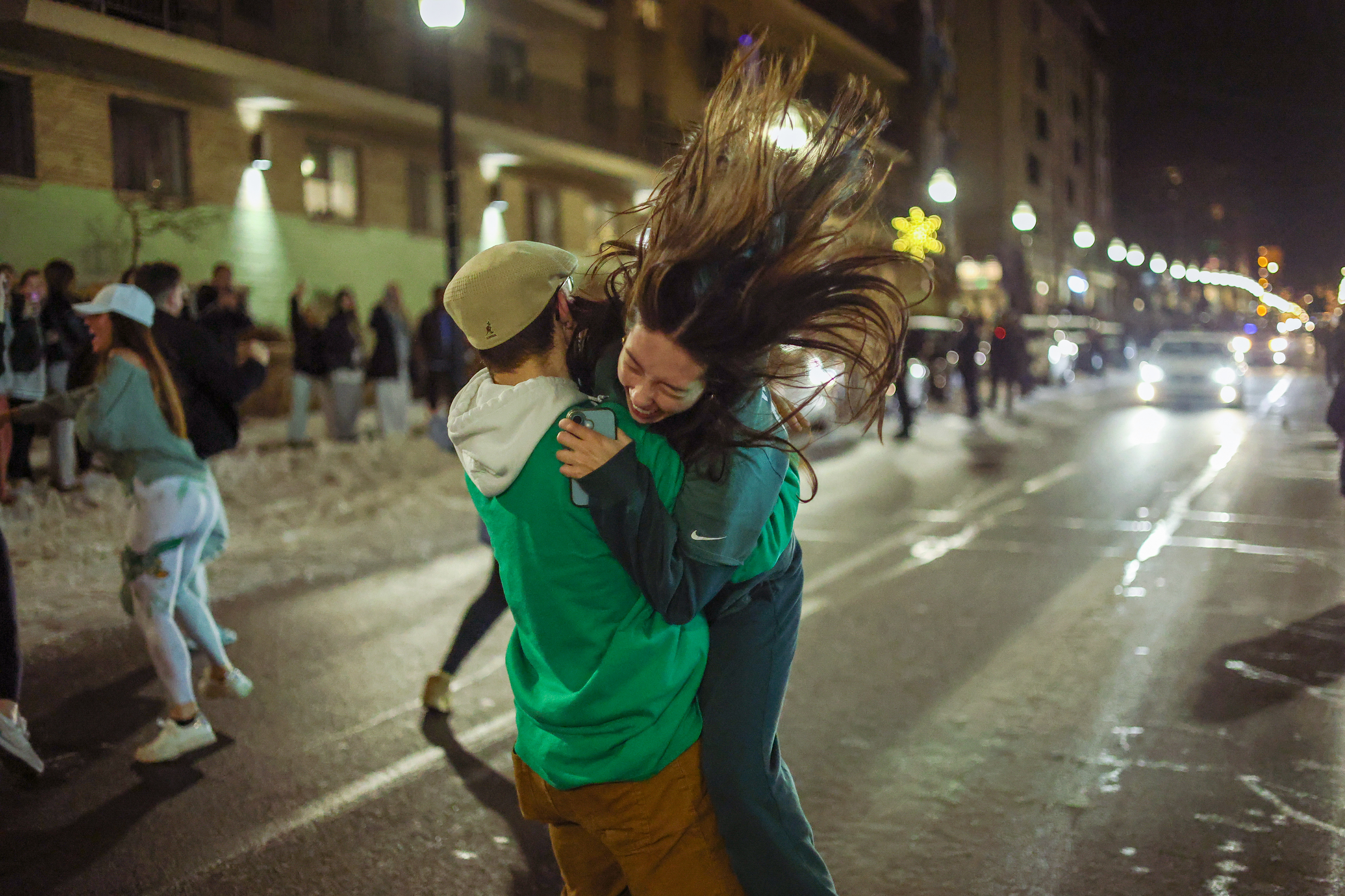 Fans of the Philadelphia Eagles hug in the streets of downtown State College on Sunday, Feb. 9, 2025. The Eagles beat the Kansas City Chiefs 40-22 in Super Bowl LIX.
