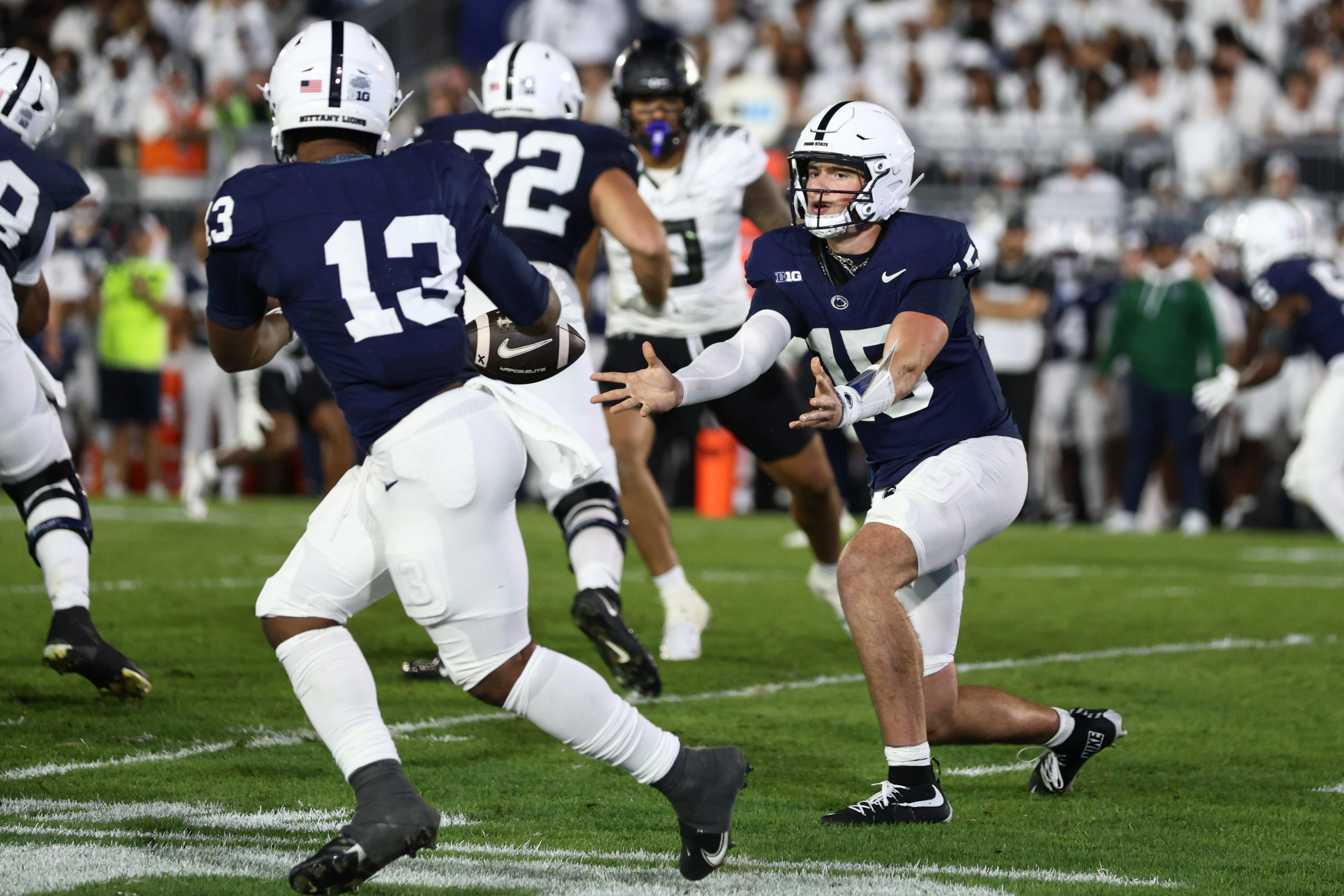 Penn State Nittany Lions quarterback Drew Allar (15) tosses as ball to Penn State Nittany Lions running back Kaytron Allen (13) during Penn State's White Out game against Oregon at Beaver Stadium on Saturday, Sept. 27, 2025 in University Park, Pa. The Ducks beat the Nittany Lions in double OT 30-24.