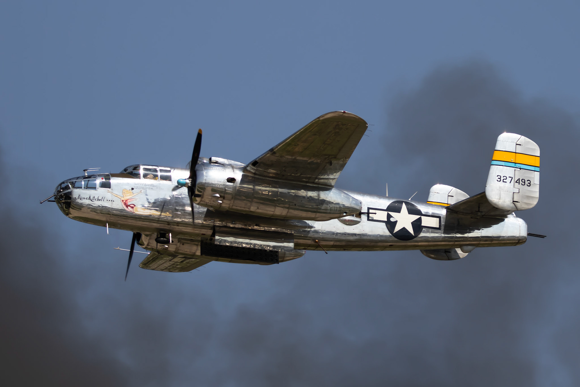 A B25 flys through a cloud of smoke