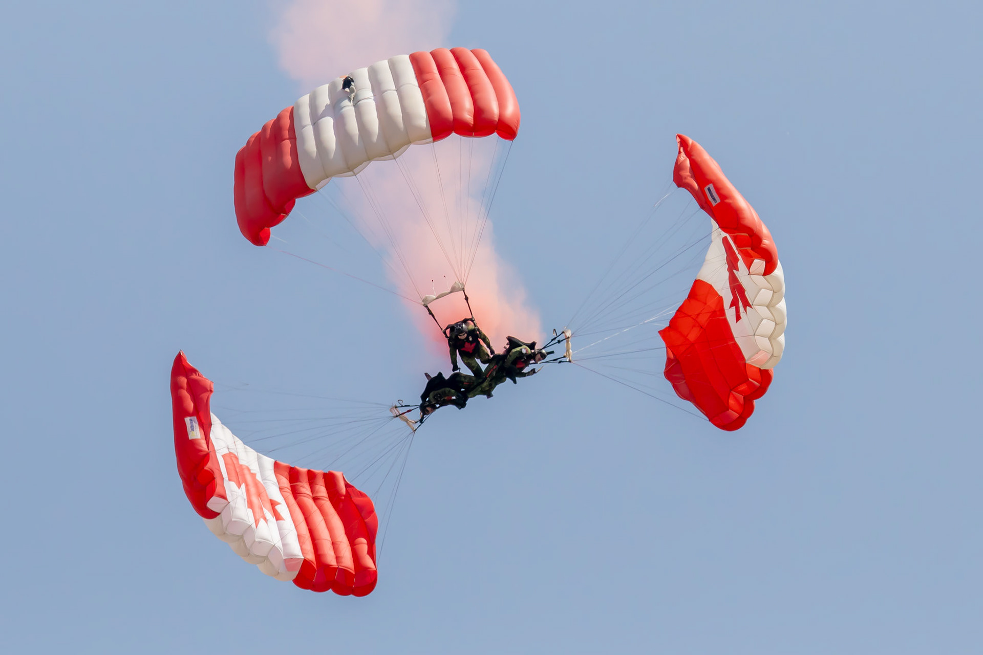 3 interlocked members of the RCAF parachuting team