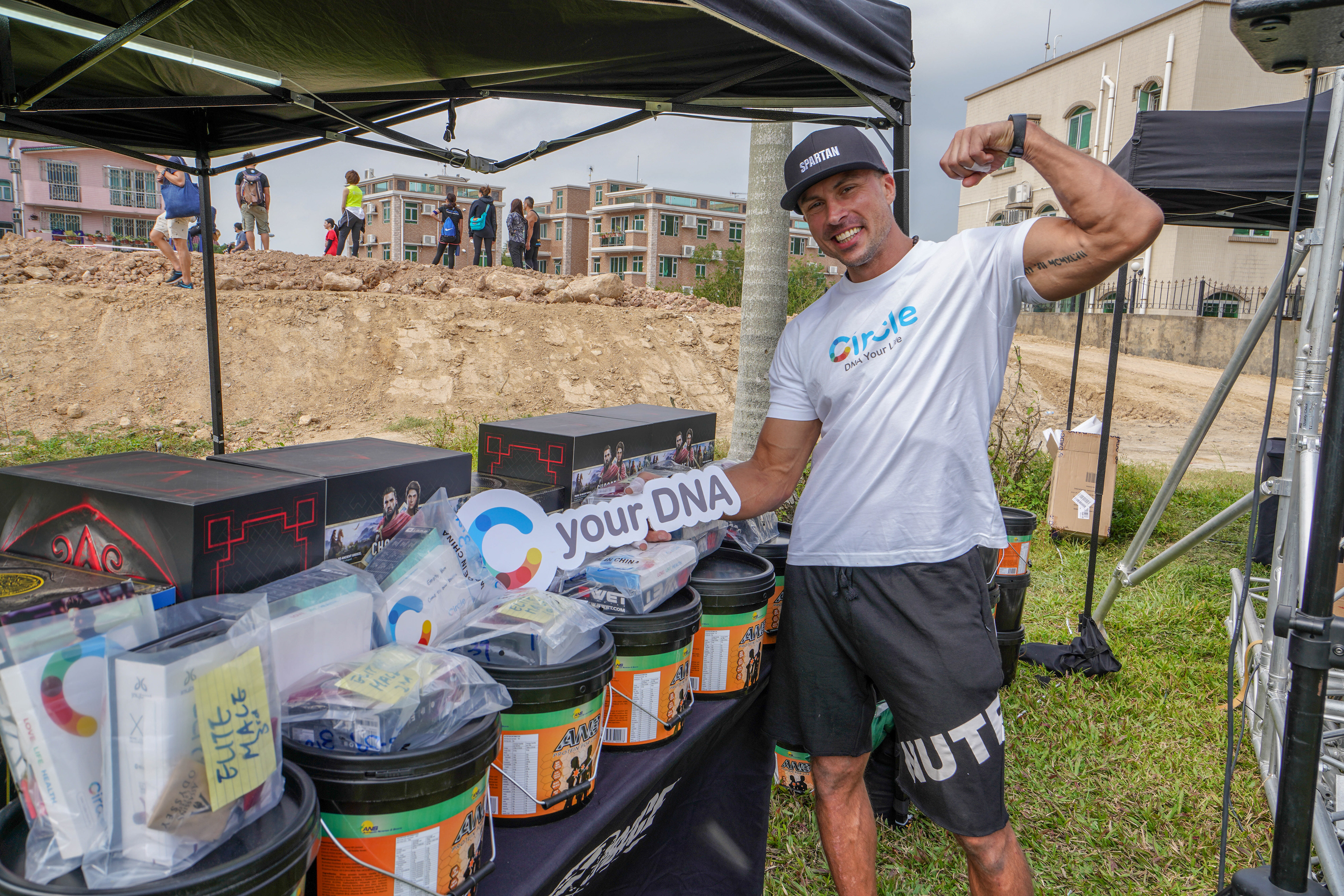 Mack Fitt posing in front of our Circle DNA Test Kit prizes to give to the winners of the Spartan Race.