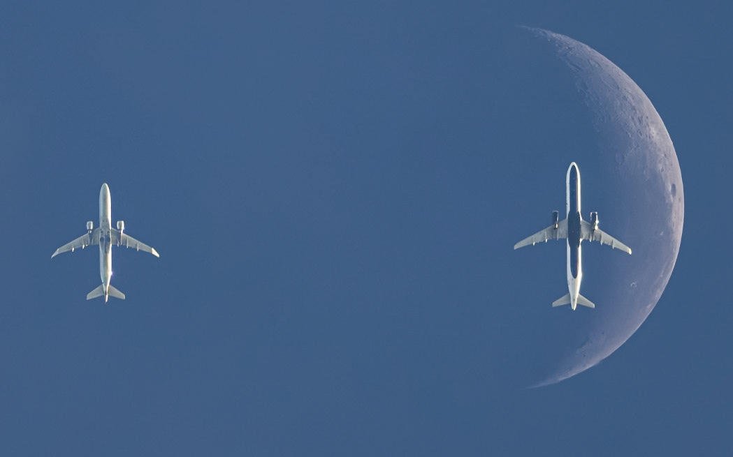 Two planes, one Moon: This is a composite of two images captured two minutes and six seconds apart, aligned on the Moon, basically the Monday morning view above the Space Coast. The Moon is only ~21% illuminated, so it's not terribly prominent, but prominent enough to be seen as it passed from east to west behind the flight route into Miami. (That's right to left, the way I have this frame oriented.)The left plane passed overhead first, an Embraer E175LR (reg N218NN) operated by Envoy for American Eagle. Flight 3375 was traveling from Columbus (CMH) to Miami (MIA) at 30,268 feet and 472 knots. The second flight was a direct hit, an Airbus A321-231 (reg N970JB) arriving 2 minutes later. That's JetBlue Airways flight 2293 traveling from New York (JFK) to Miami (MIA) at 34,000 feet and 478 knots. This frame is the base frame for the Moon, and I submit it as evidence that I'm not photoshopping the transits I post, as it's seriously bugging me that the plane isn't centered in the crescent, and if I were shopping it, I'd center the darn thing. Despite a 10-frame-per-second shutter, this is the closest to the center. It's fast: the jet is only in front of the Moon for three frames total. Shots by me; flight data from Flightradar24.