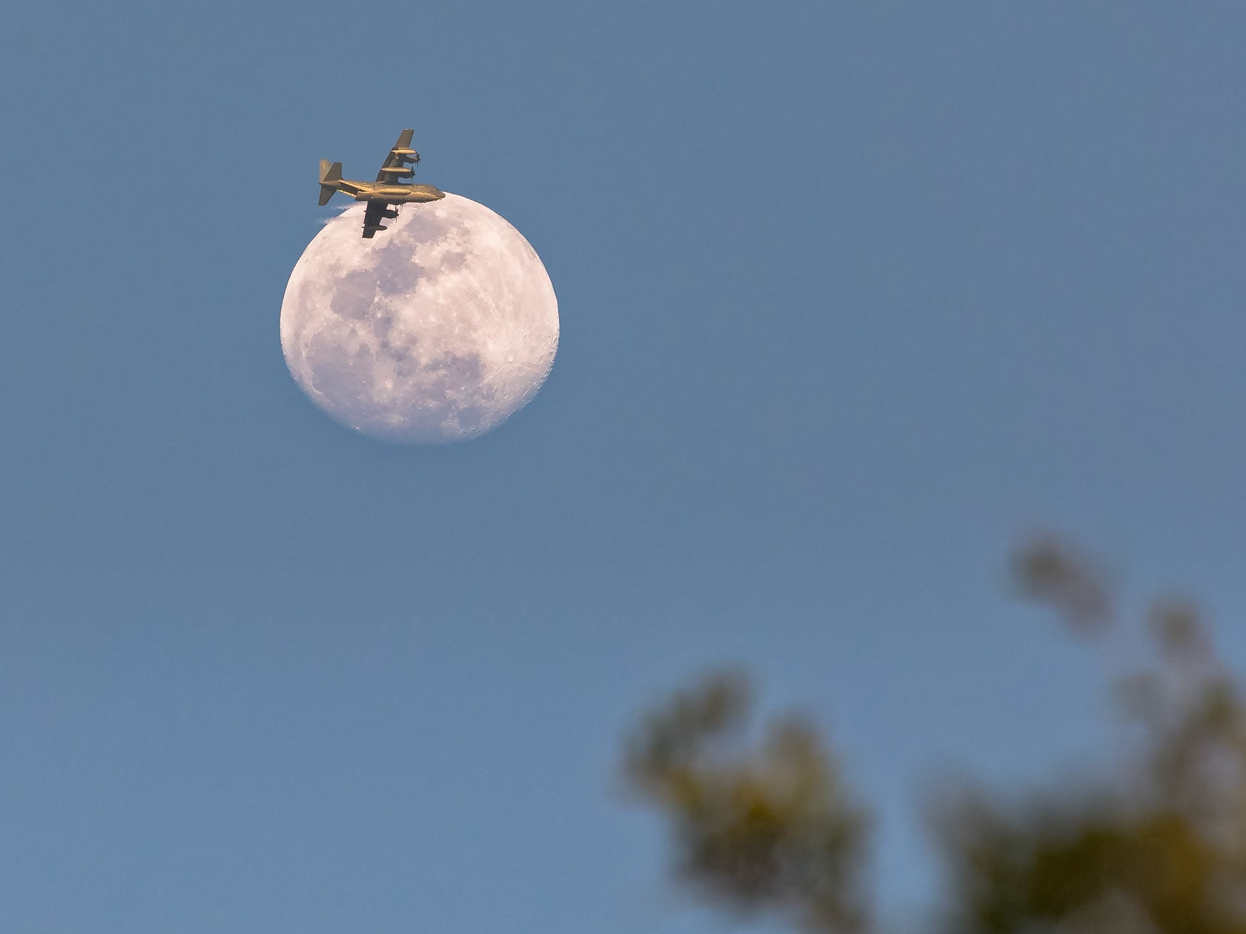 I spend a ton of time looking at the Moon, and this is, in fact, the first time I've happened to catch an airplane-lunar transit.And what an airplane it is: that's most likely the HC-130 from the 920th Rescue Wing from Patrick Air Force Base, Florida, and if you look closely, you can see that the loading (and maybe, in this case, unloading) ramp is down/open.I was in the backyard trying to shoot the 89% illuminated waxing gibbous Moon through the trees, and this plane came into view. I didn't have time to switch equipment (I had the right lens but the wrong, full-frame, camera), but it all worked out well enough.(Photo by Michael Seeley)