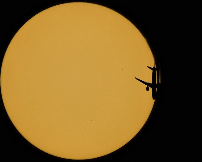 The Sun + Air Canada flight 1206 traveling Sunday from Montreal (YUL) to Miami (MIA), seen from the Space Coast of Florida -- from my driveway, specifically. The Airbus A220-300 was flying at 34,000ft &amp; 521kts as it passed in front of the Sun. (📷: me w/ flight data by Flightradar24.com)