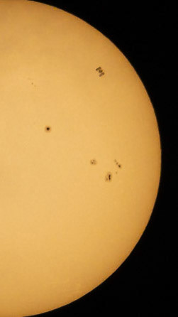 Not a sunspot (look at all of them!): Look closely, and you'll see the International Space Station (carrying seven humans) traveling at 17,500 mph caught Monday, passing in front of the Sun, visible through thin clouds from the Space Coast of Florida.
