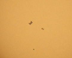 I was hoping to catch a shot of the illuminated International Space Station flying over the Space Coast tonight, but it was too cloudy, so here's a pic from Monday of the ISS silhouetted against the Sun, casually passing by some sunspots. (1/5000-sec, f10&amp;ISO500 @ 700mm w/ a solar filter)