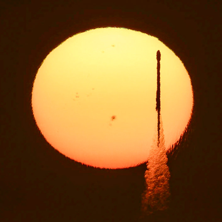 The SpaceX Falcon9 GPSIIISV06 launch was initially scheduled for 7:10 am (ET) Wednesday, January 18, 2023, or 5 minutes before sunrise. A crescent Moon was in the sky, so I planned to line up the rocket with the Moon. To do so required me to be at a specific location on Playalinda Beach, .6 miles from the nearest parking spot. I got there early enough to get a place in the closest lot and started the march along the beach with not-weightless gear in tow. By 6:40, I was approaching the pin on my map when I got the text from none other than Mr. John Kraus: "NEW T-0 7:24." Back to the car I went, my watch screaming at me, wondering if I was working out, and eventually, having a cardiac event. I headed west, and with the quick help of PhotoPills, The Photographer's Ephemeris, and flightclub.io, John and I settled on a location in the Merritt Island National Wildlife Refuge. I reached it at 7:08 pm, just enough time to find a break in the trees and set up gear. The Sun rose at 7:15, and it wasn't immediately clear that it would make it over clouds low on the horizon, but with 4 minutes to spare before launch, the Sun (with all its sunspots) was where it needed to be, and at 7:24, so was the rocket. It was magical.   John's shot is really great, you should go check it out, and if you aren't following him, you should be. Find him at John Kraus Photos.Captured using a Canon R5+RF100-500L &amp; 1.4x TC.