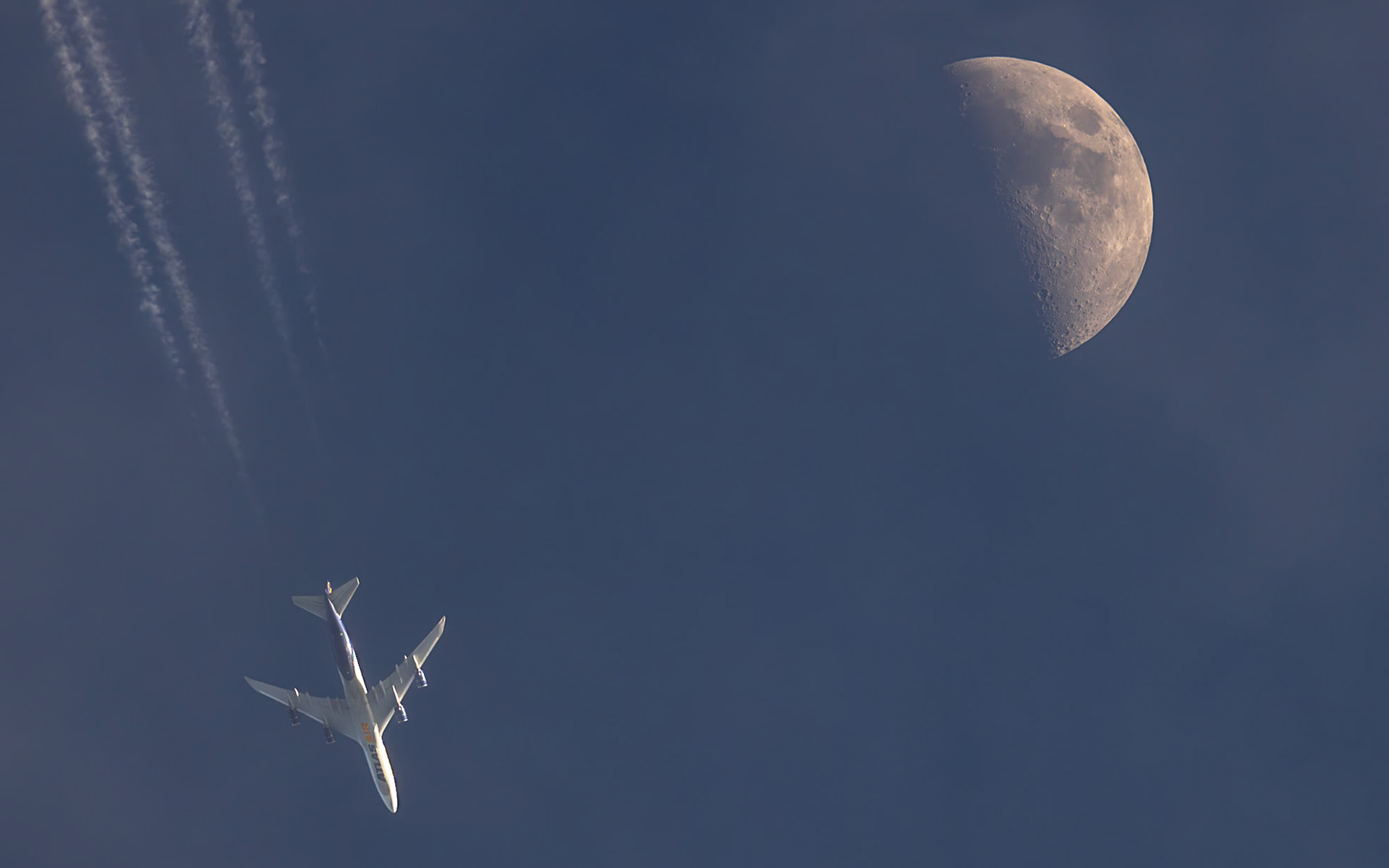 close (adjective)being near in time, space, effect, or degreeThese almost-lunar transits from Saturday are mainly remarkable because of the planes involved, both of them huge and photogenic from a #planespotting perspective. The unbothered Moon is almost secondary. I was tracking the first jet closely, a Boeing 787-9 Dreamliner (reg C-FVLX, listed as "Disney Wish Livery"). The timing seemed right for a direct hit, but Air Canada flight 1202 from Toronto (YYZ) to Miami (MIA) was traveling two-ish minutes too fast, and it passed just to the right of the Moon, 36,601 feet above me and moving at 458 knots. When a plane is that close to a transit (and to the west of the Moon/Sun), anything on that same flight path between two and six minutes behind is in play for a direct hit. A Boeing 747 was coming down the route, but I estimated it would be ten minutes behind the 787. Generally, I don't chase plane transits; all but two I've captured have been from my driveway. But I made an exception for a close 747. The second shot shows the result: another miss, this time on the other side of the Moon. The 747 was a tad slower than I estimated, but even if I accounted for the extra 2 minutes (it arrived 12 minutes after the 787), I still needed to be about three times further east than I was. But even if it is not passing in front of the Moon, it is still a magnificent plane, indeed the "Queen of the Skies." It's a Boeing 747-87UF (reg N856GT) operated by Atlas Air Worldwide Holdings as flight 5Y8052, traveling from Anchorage (ANC) to Miami (MIA), 34,000 feet above me.Big thanks to TPE for helping me gauge the Moon's position and, of course, to Flightradar24.com for the flight data. "close" definition by Merriam-Webster Dictionary.