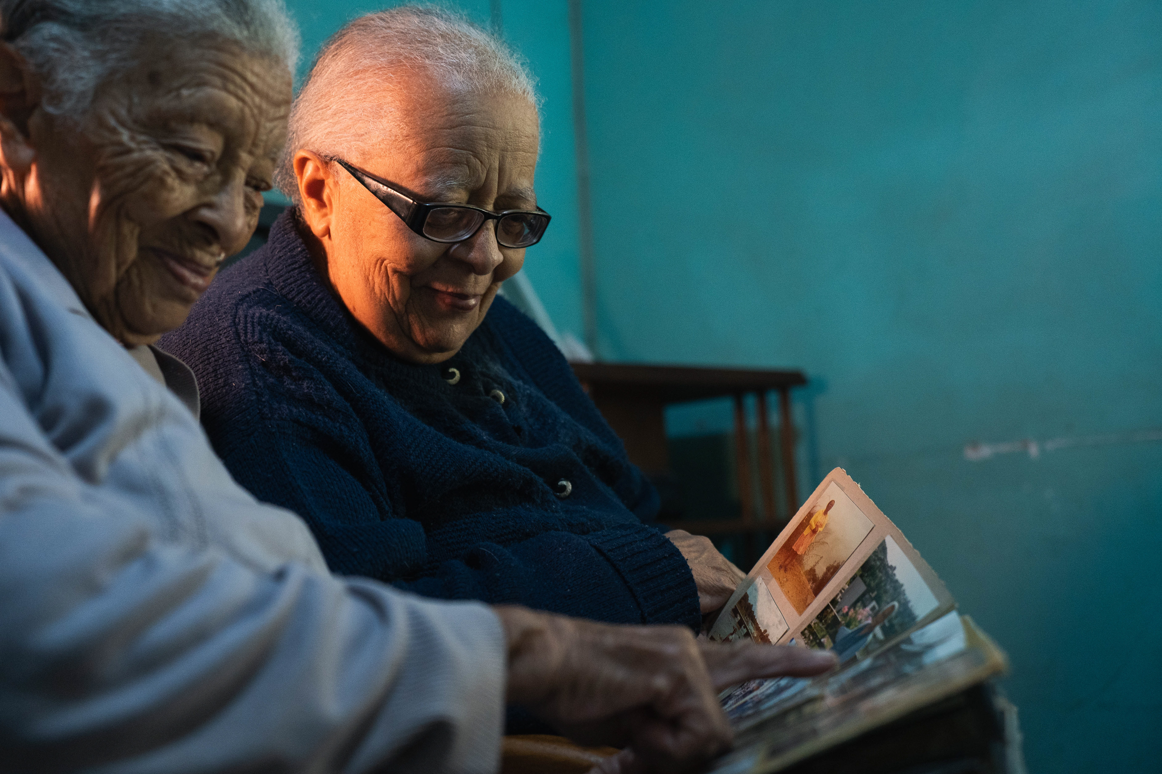 Sisters, Ethne and Edna, study an old photo album at their home. "Our paternal grandfather came from Madras, India, to South Africa. He worked as a chef on the railways in Cape Town, traveled to Zimbabwe by train, and married our grandmother, who was of Cape Coloured [from Cape Town, South Africa] and German descent. On our mother’s side we had a Ndebele Gogo and a British grandfather. Although our mother was bilingual, one of our sorrows is that we never learned to speak the Ndebele language."