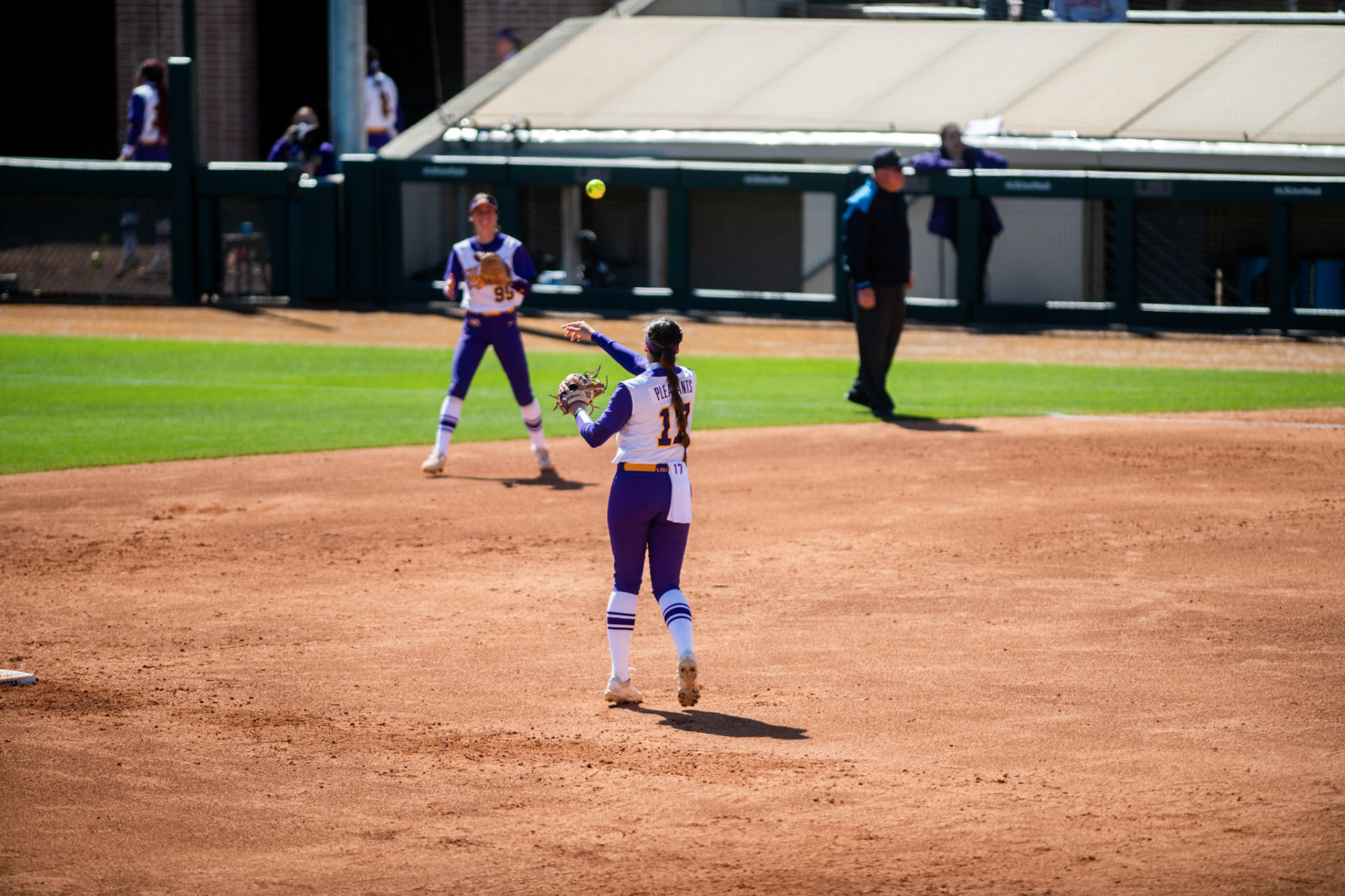 LSU softball redshirt sophomore infielder Taylor Pleasants (17) throws the ball to redshirt freshman infielder Presley Pilon (99) Saturday, March 12, 2022 during LSU's 13-6 win against Alabama at Tiger Park in Baton Rouge, La.