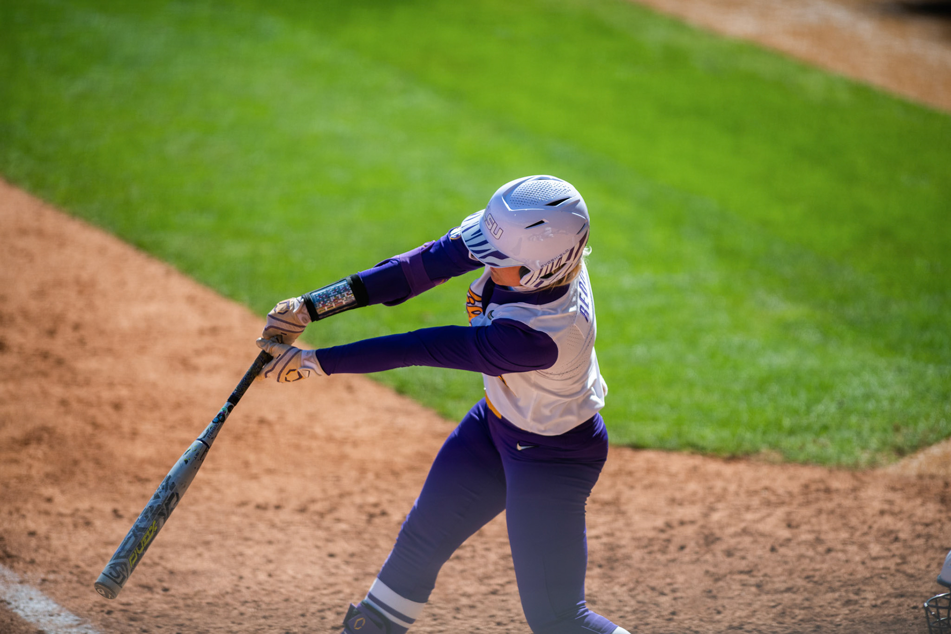 LSU softball freshman outfielder McKenzie Redoutey (4) swings Saturday, March 12, 2022 during LSU's 13-6 win against Alabama at Tiger Park in Baton Rouge, La.