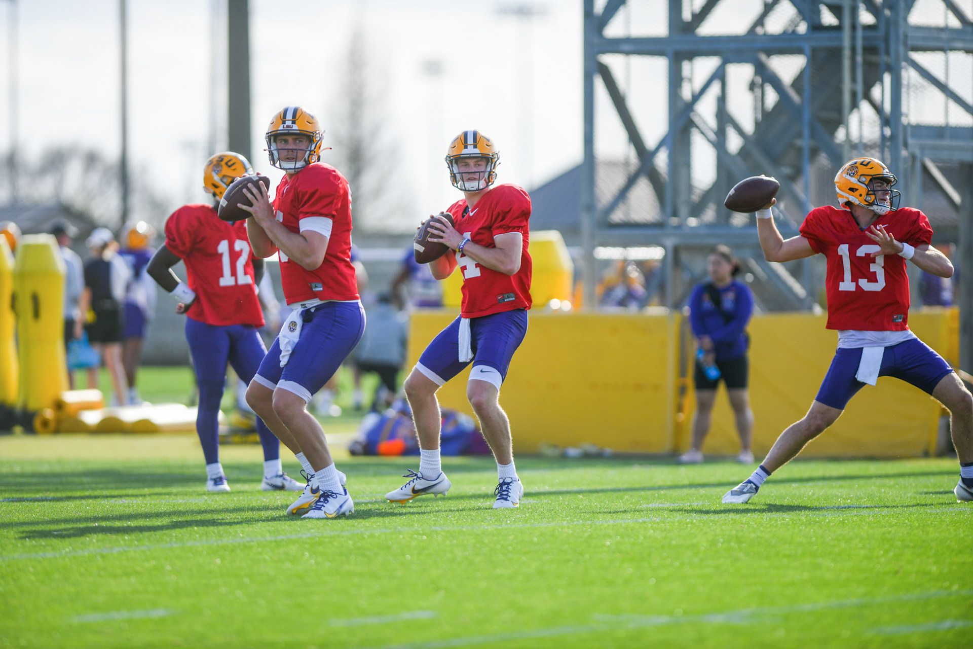LSU football quarterbacks Garrett Nussmeier (13), Walker Howard (14), and Myles Brennan (15) prepare to throw the ball Tuesday, March 29, 2022 during LSU's spring practice in Baton Rouge, La.