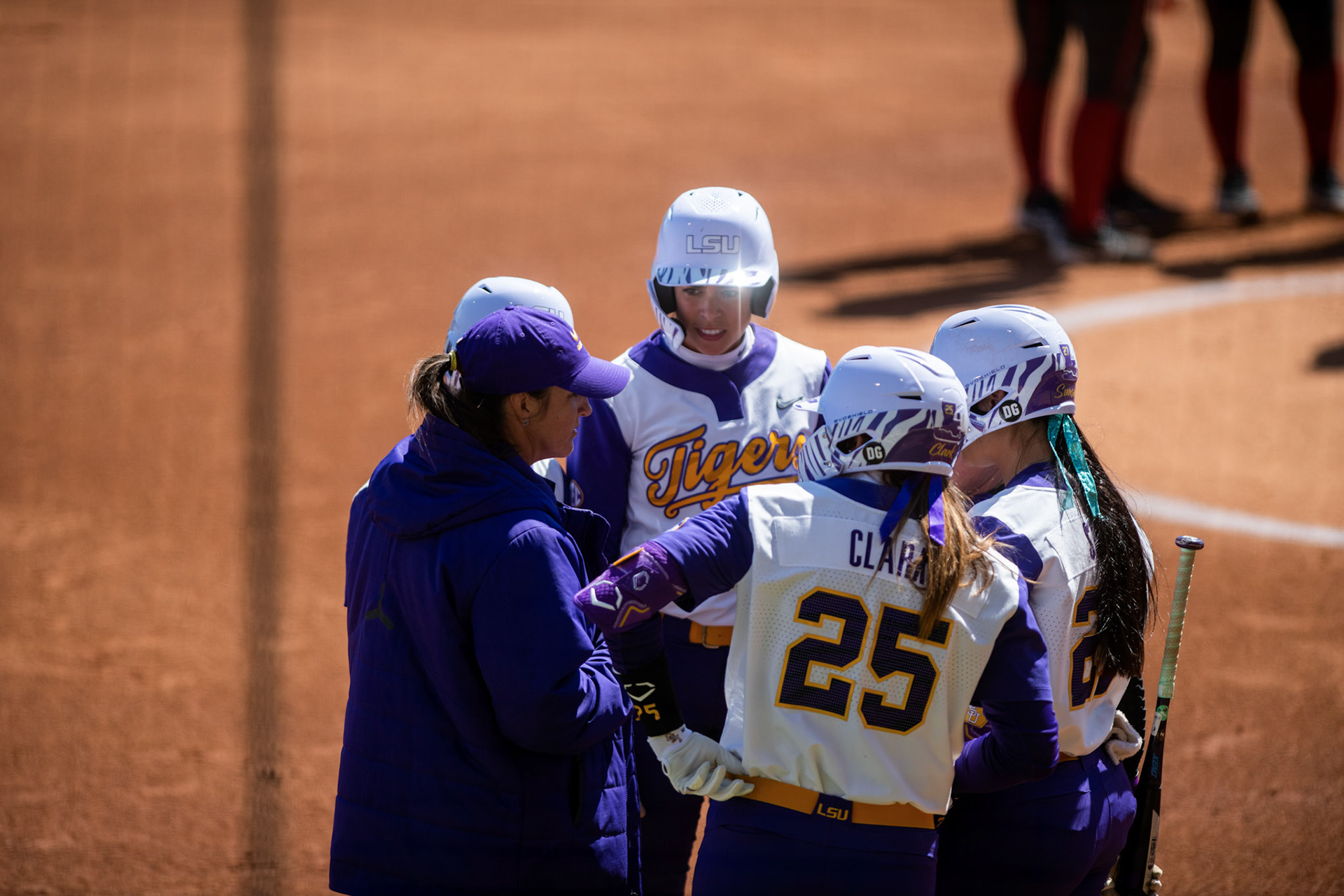 LSU softball head coach Beth Torina talks to redshirt sophomore infielder Taylor Pleasants (17), redshirt junior infielder Georgia Clark (25), and 5th-year senior pitcher/utility Shelbi Sunseri (27) Saturday, March 12, 2022 during LSU's 13-6 win against Alabama at Tiger Park in Baton Rouge, La.