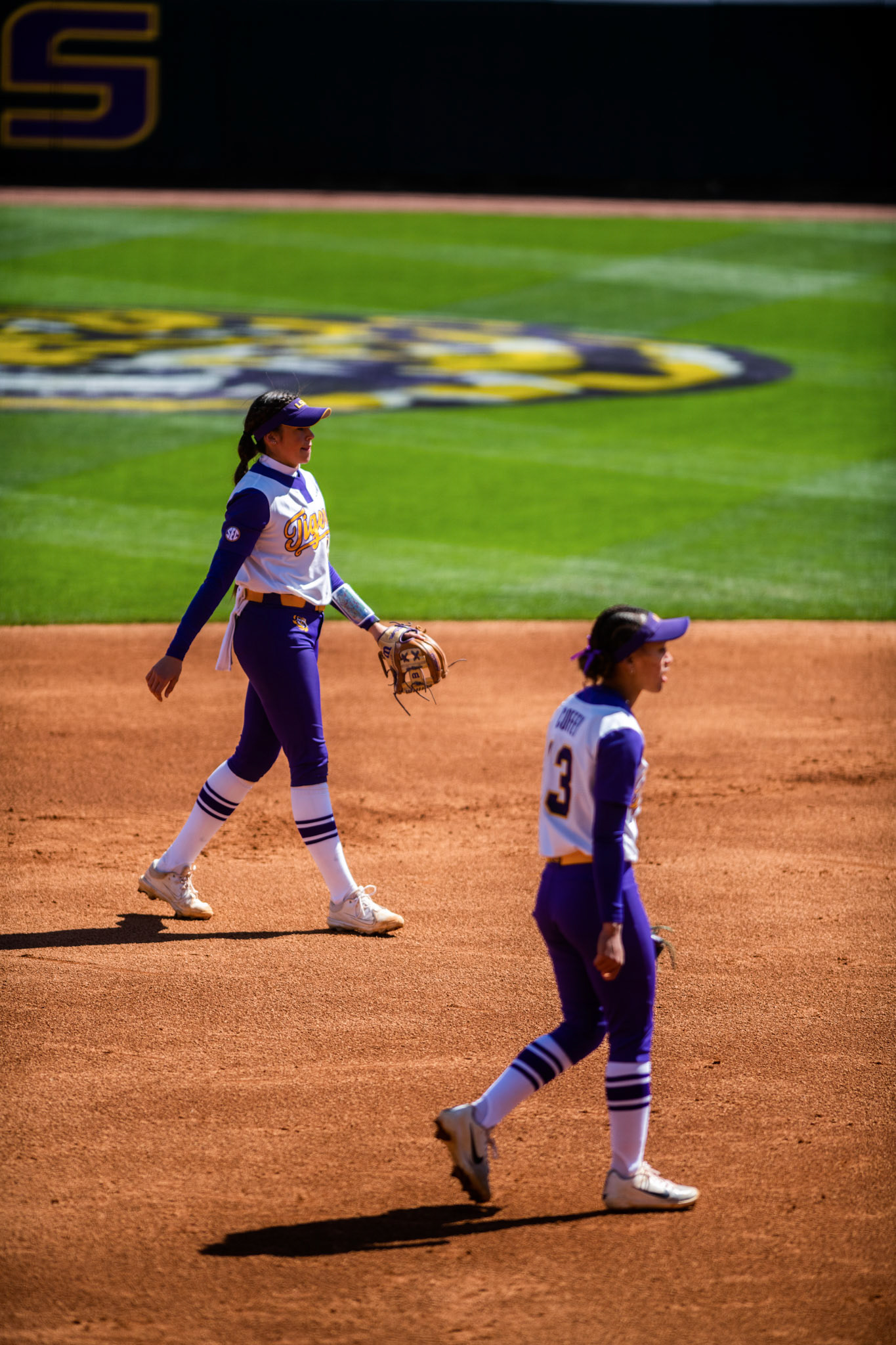 LSU softball redshirt sophomore infielder Taylor Pleasants (17) and sophomore infielder Danieca Coffey (13) walk to the pitching circle Saturday, March 12, 2022 during LSU's 13-6 win against Alabama at Tiger Park in Baton Rouge, La.